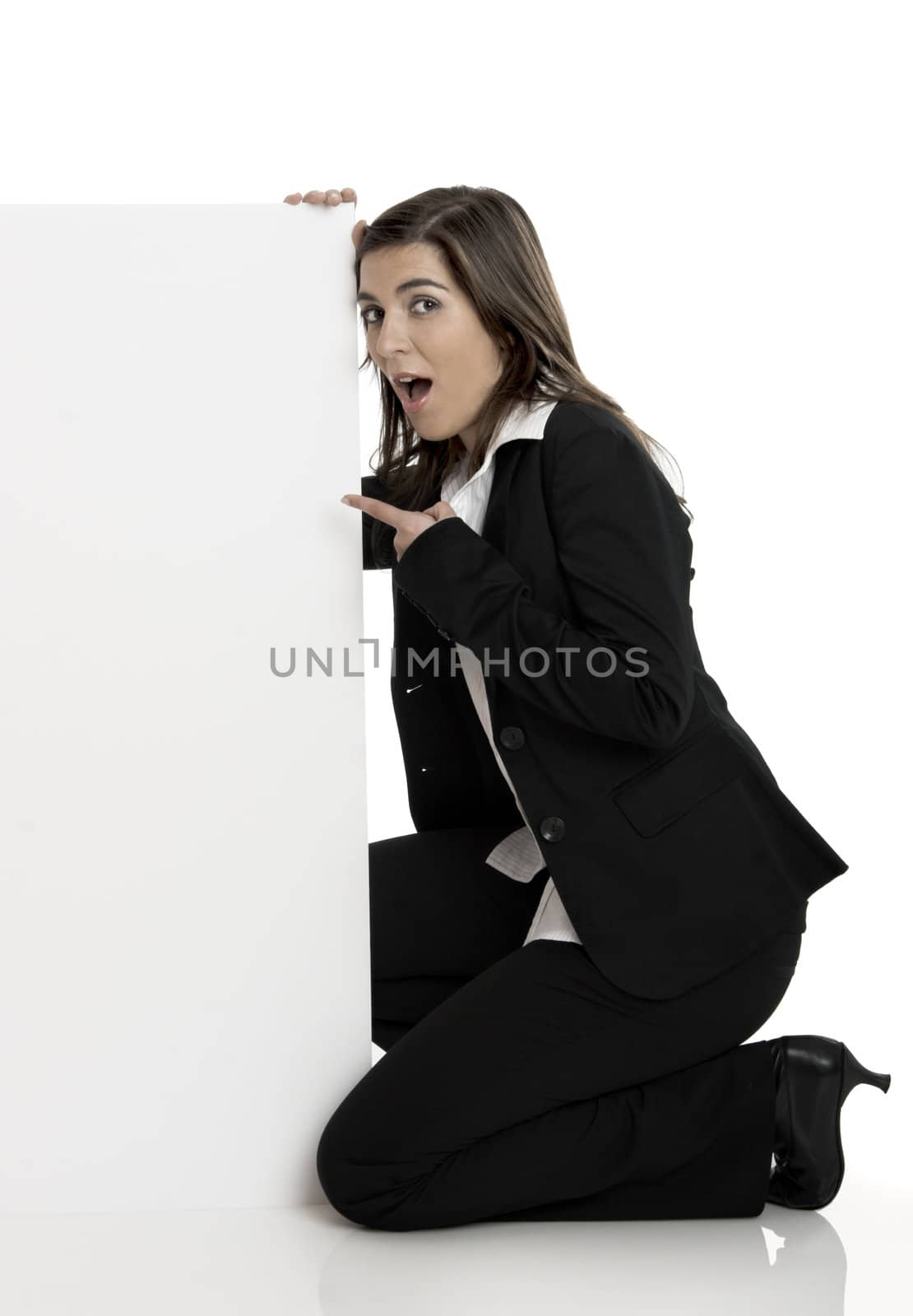 Portrait of a beautiful surprised woman holding a blank billboard