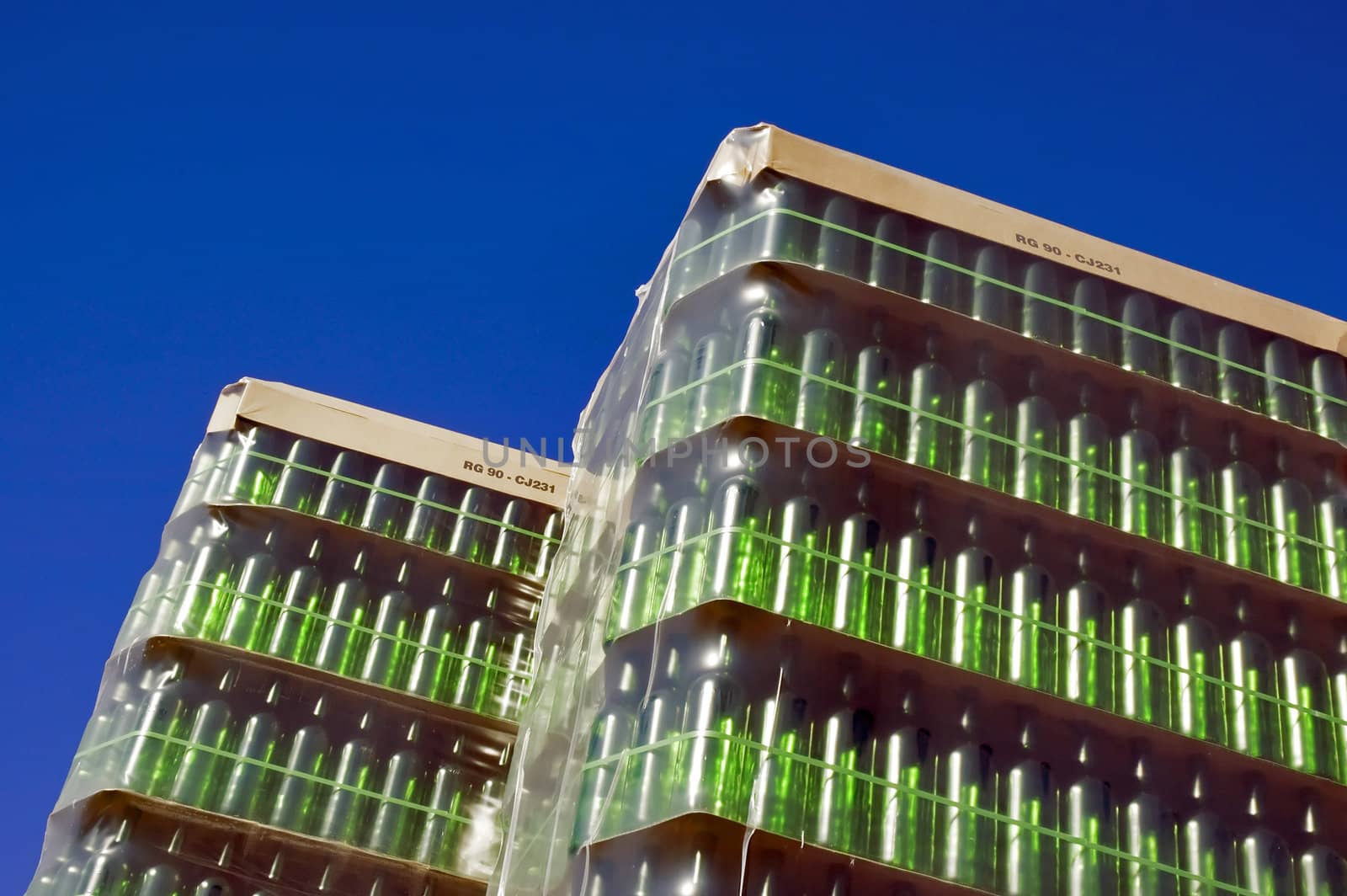 Stack of green glass bottles by mrfotos