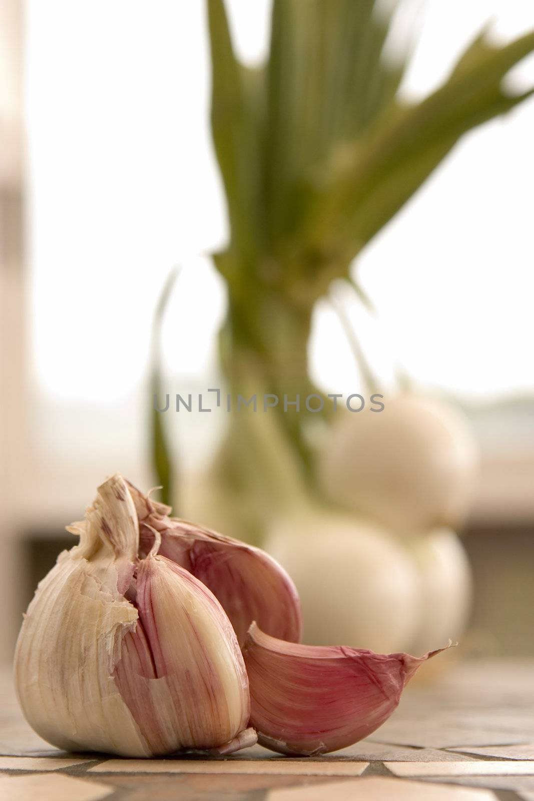 Some segments of garlic lay on a kitchen table
