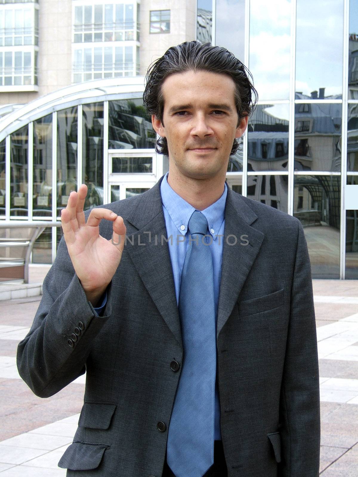 Businessman making ok sign with his fingers