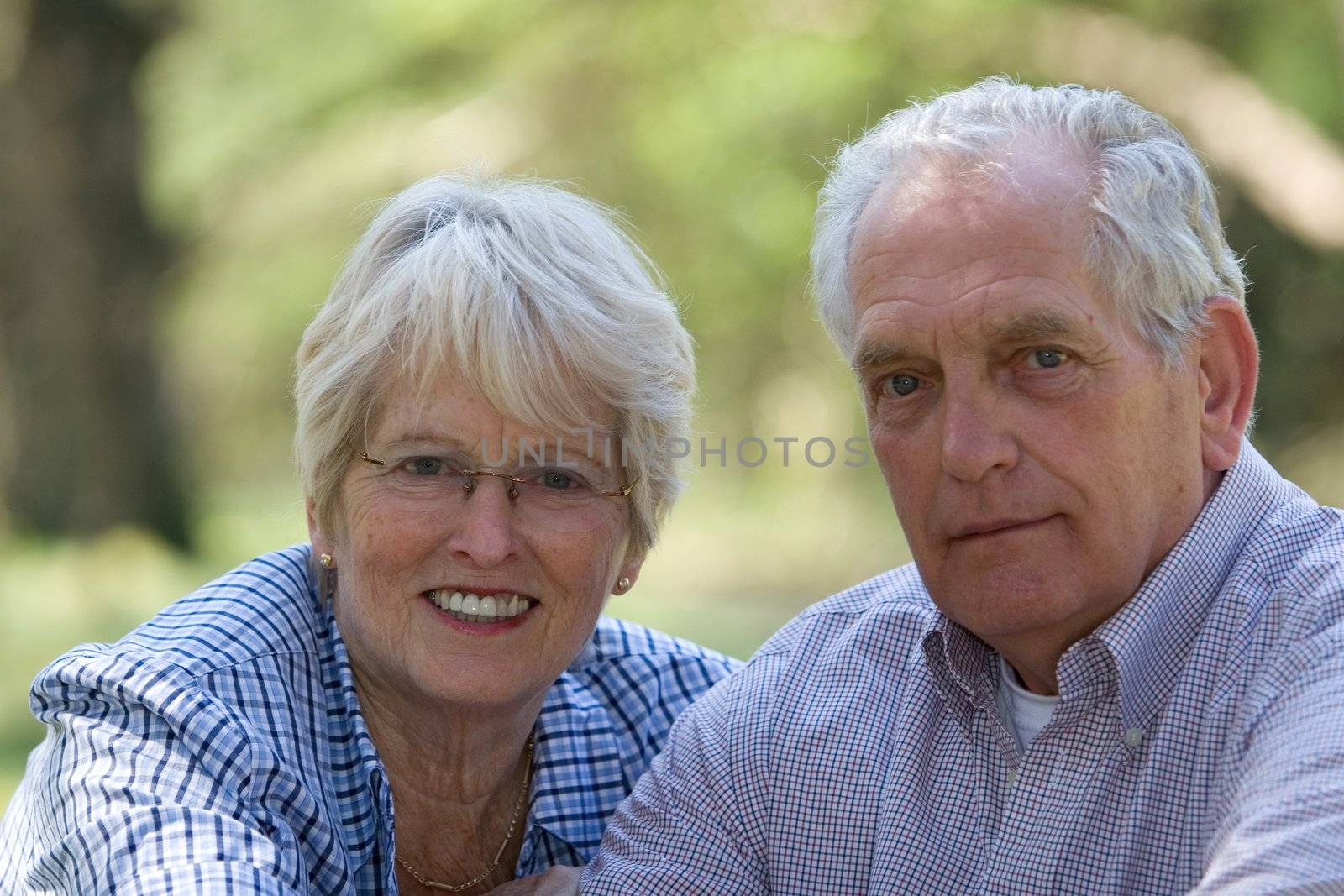 Lovely senior couple outdoors on a summerday (focus on woman)