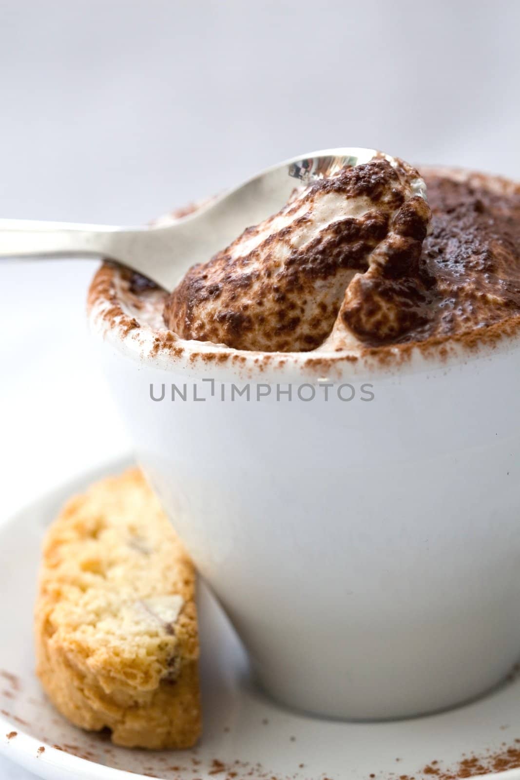 Small italian coffee cup filled with creamy mascarpone dessert topped with a little bit of chocolate