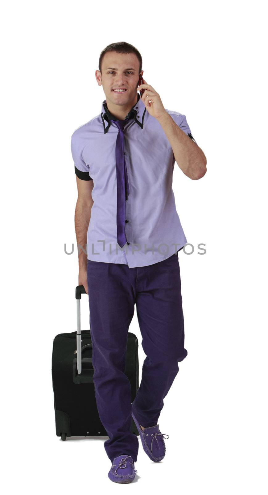 Image of a young casual man with suitcase and mobile phone.