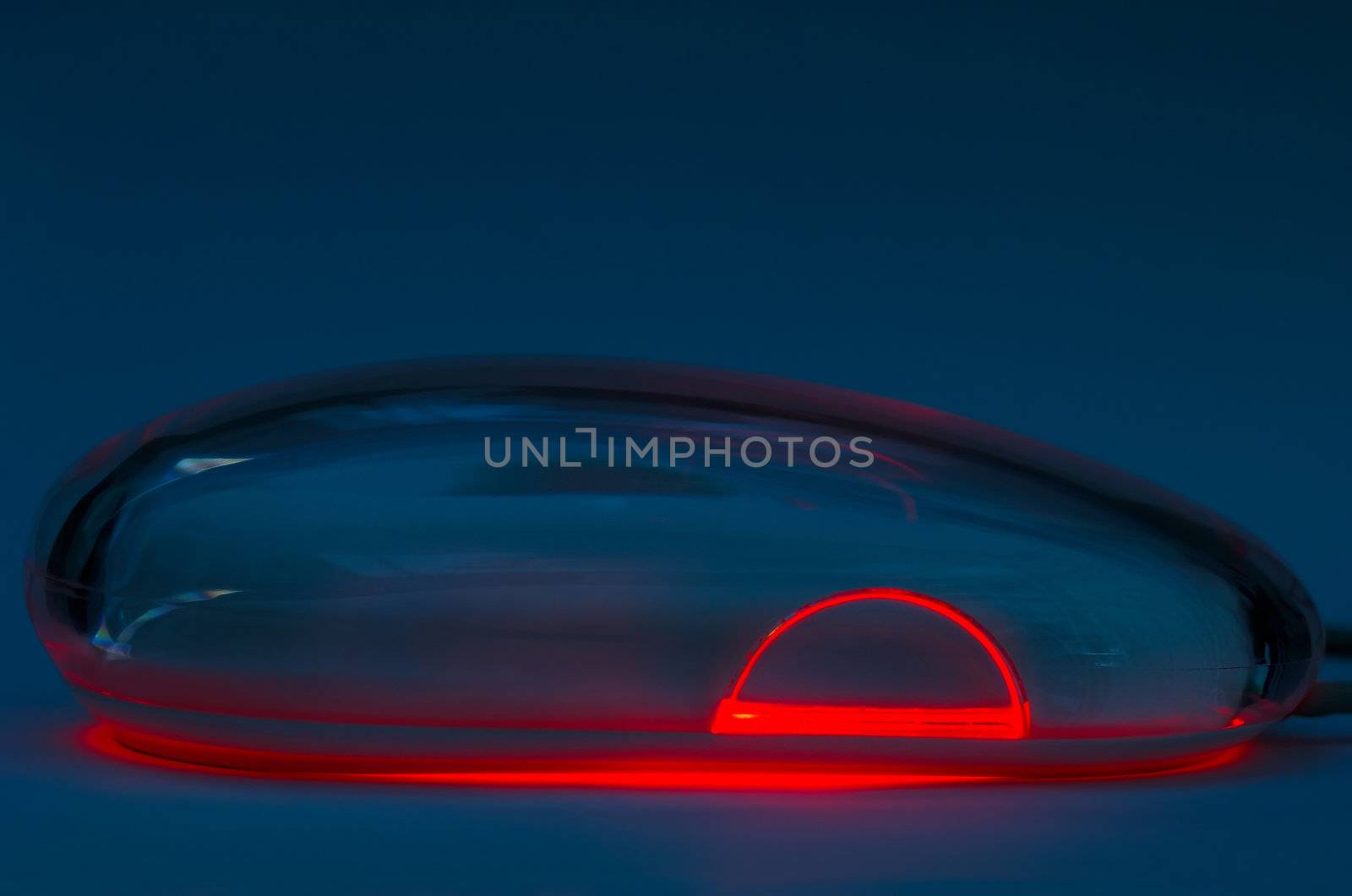 Image shows an optical mouse in a low light surroundings