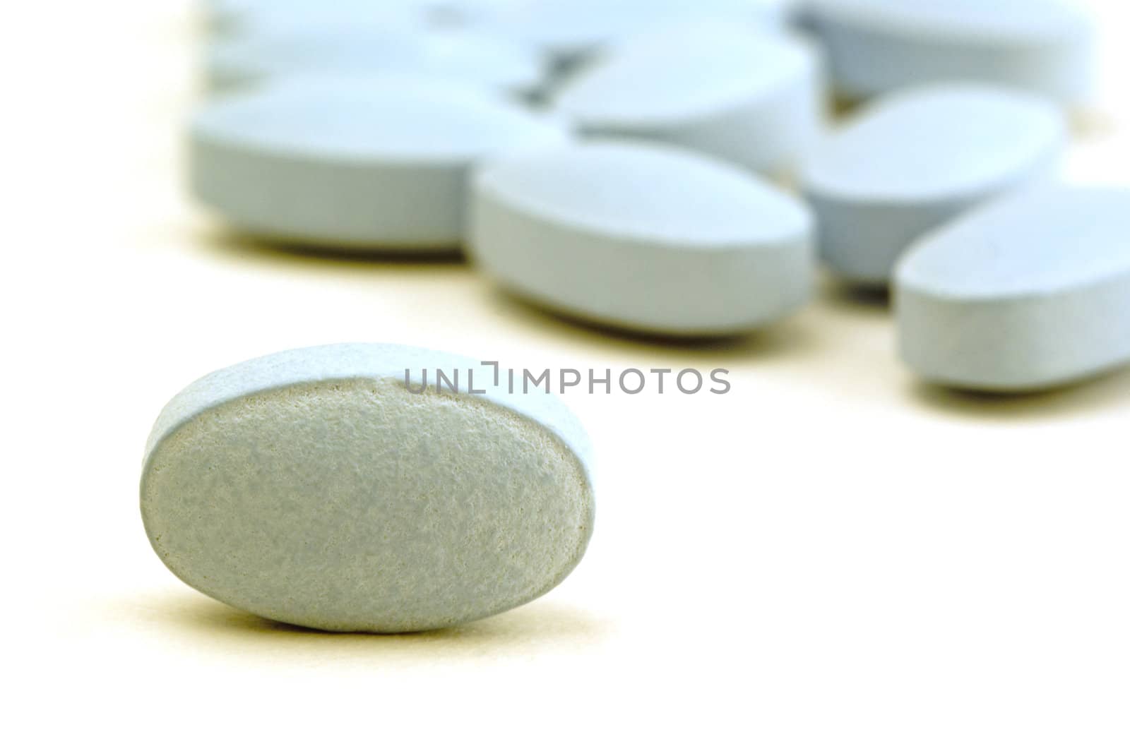A macro shot of blue pills on a white background