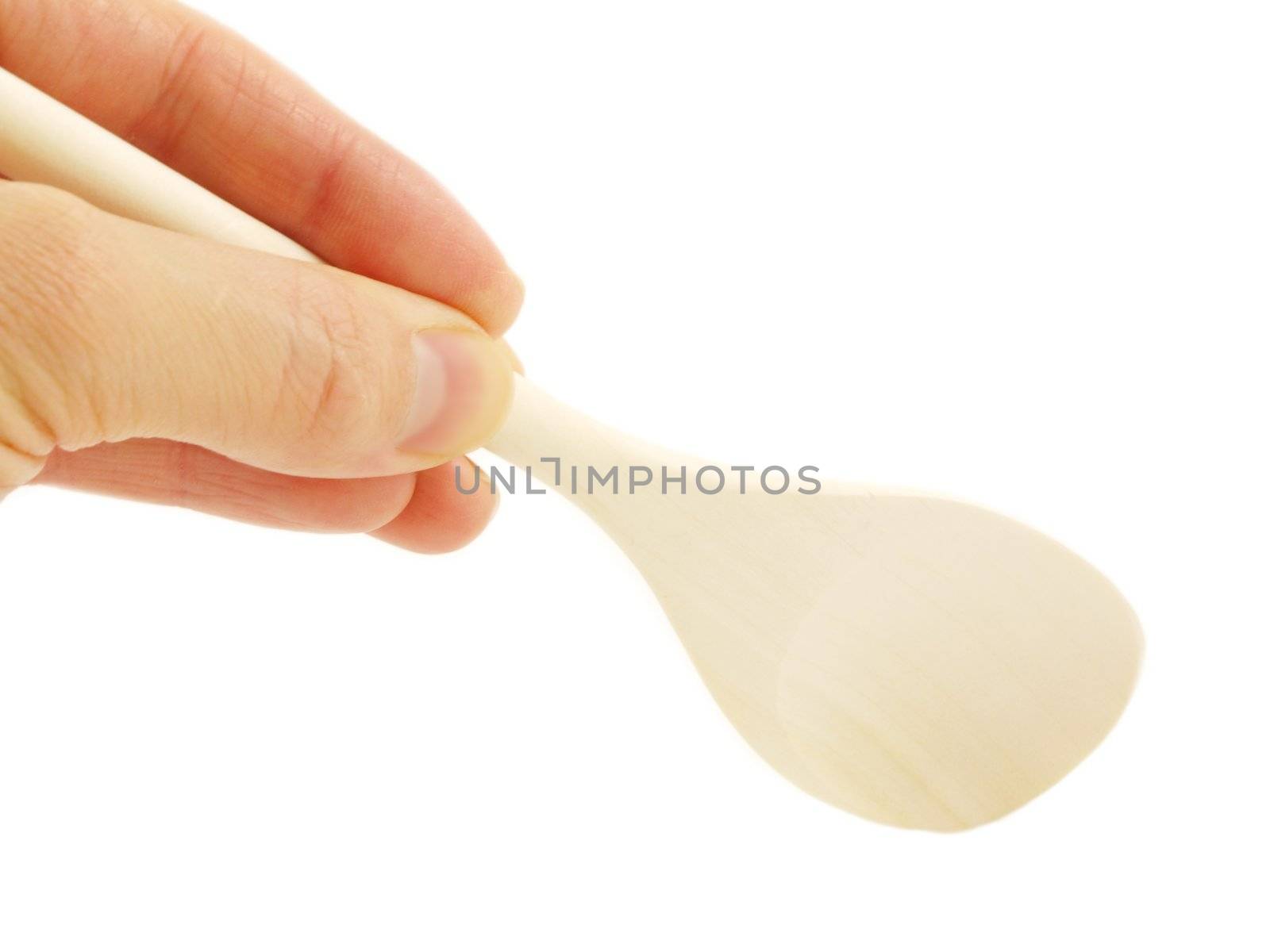 Person holding a wooden spatula, isolated towards white background