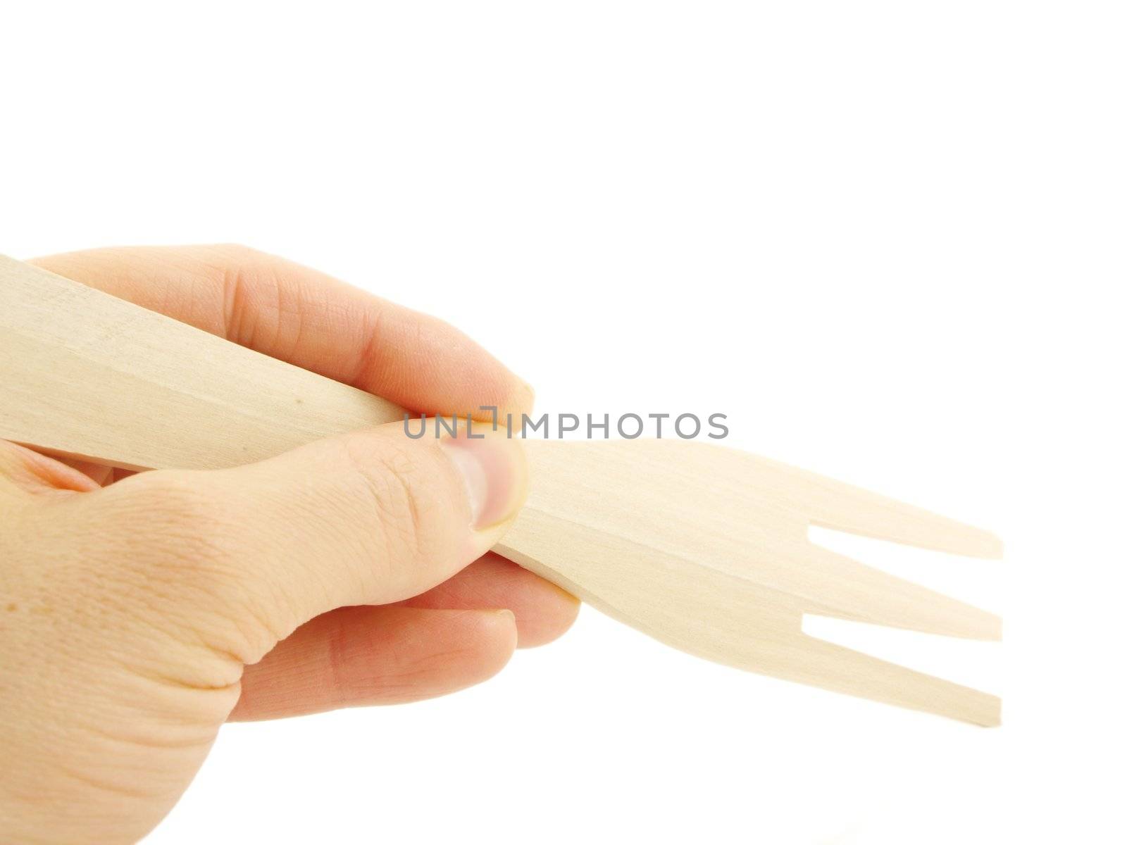 Person holding a wooden spatula fork, isolated towards white background