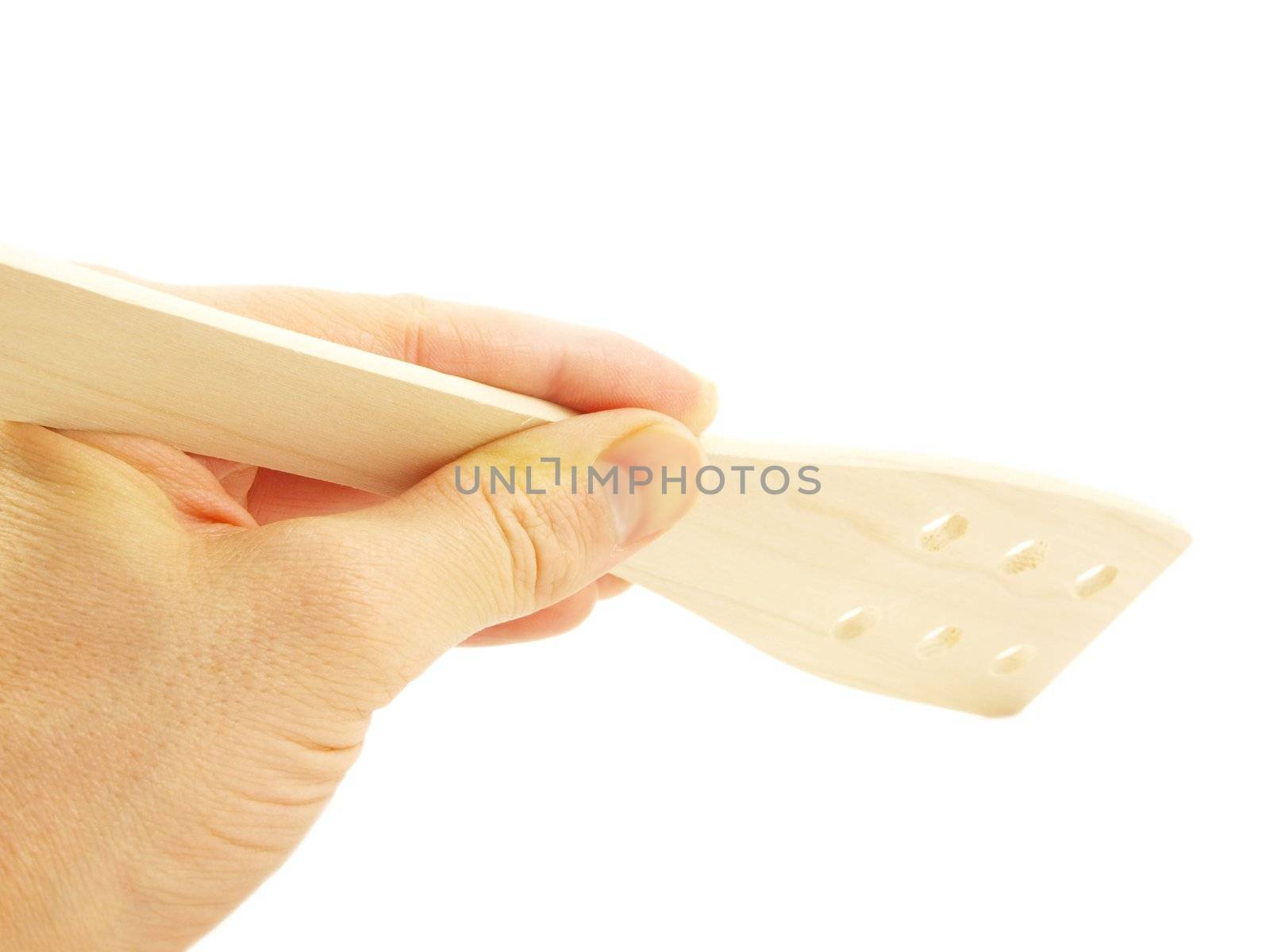 Person holding a wooden flat spatula, isolated towards white background