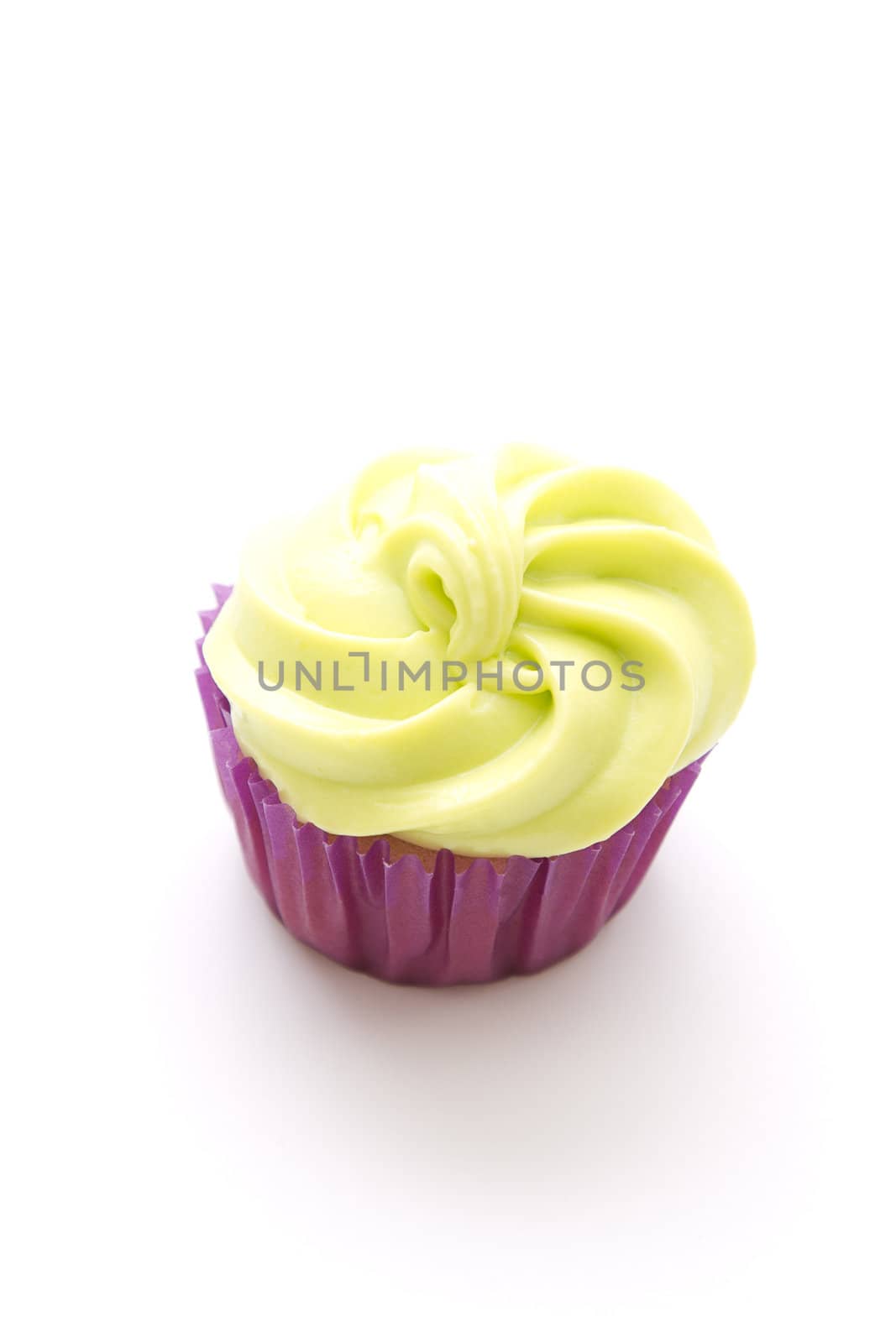 small cupcake in purple paper cup with green frosting