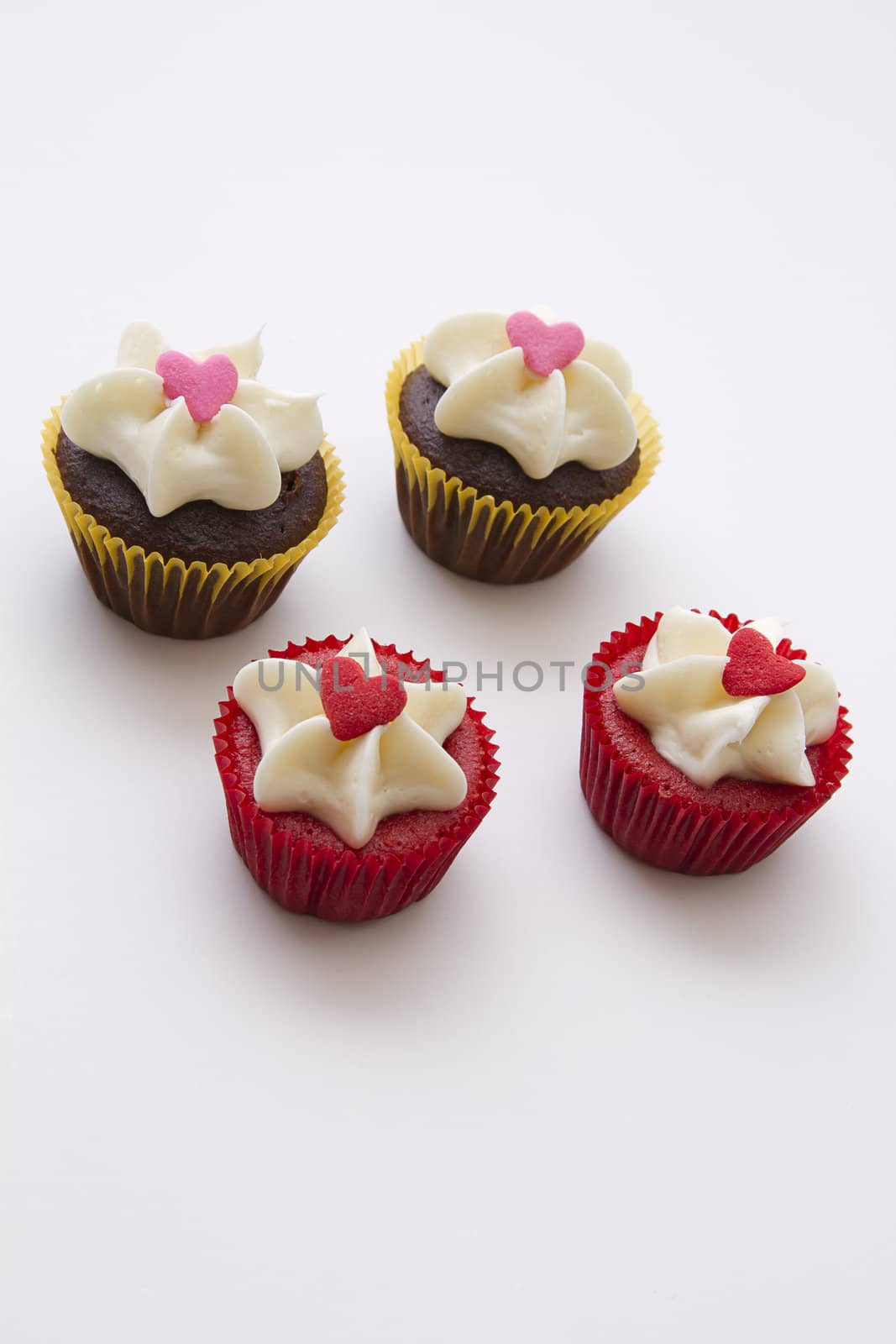 bite size cupcake decorated with white frosting and candy heart