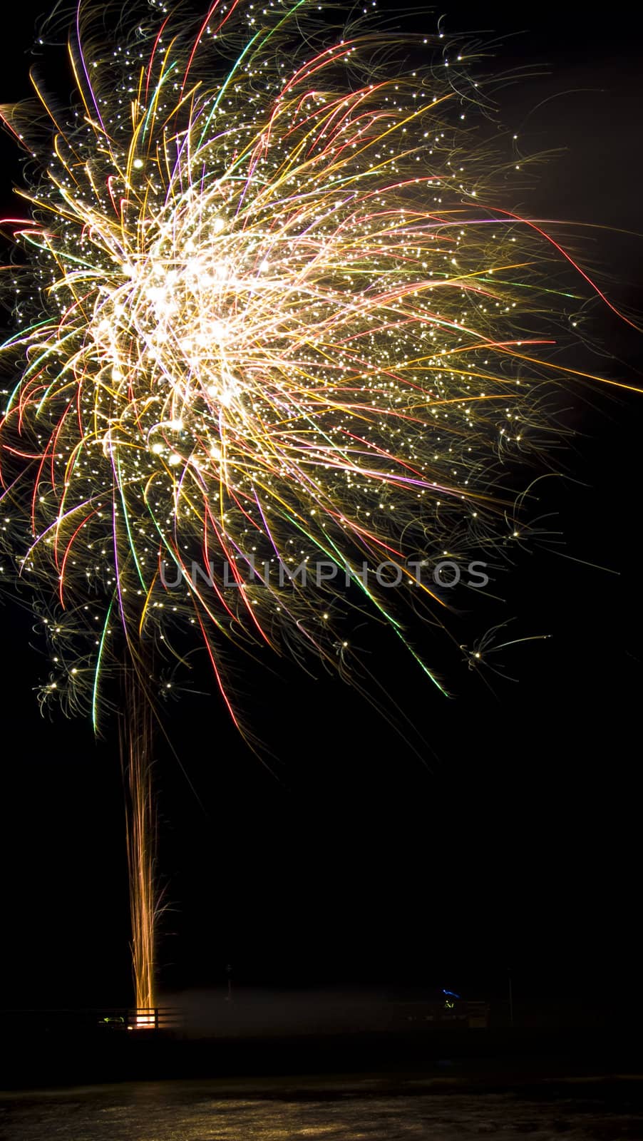 colorful fireworks display with reflection in water