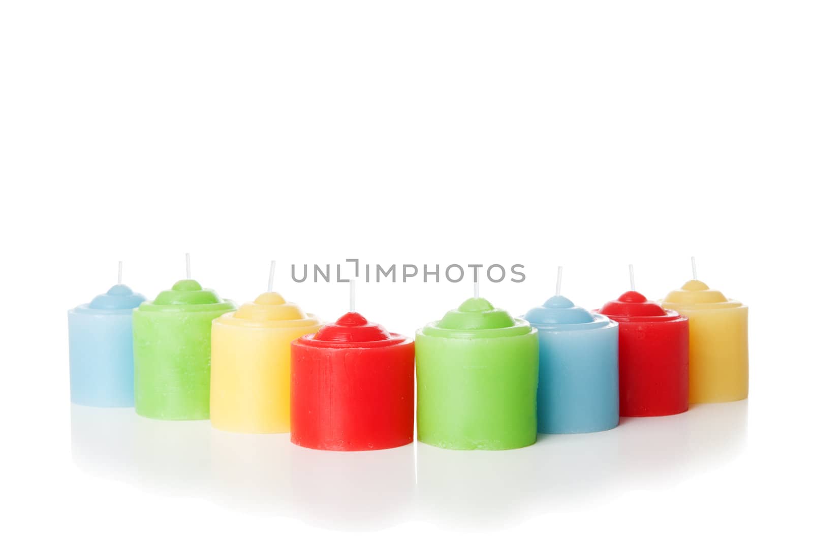 Colorful short candles without flame. Isolated over white background