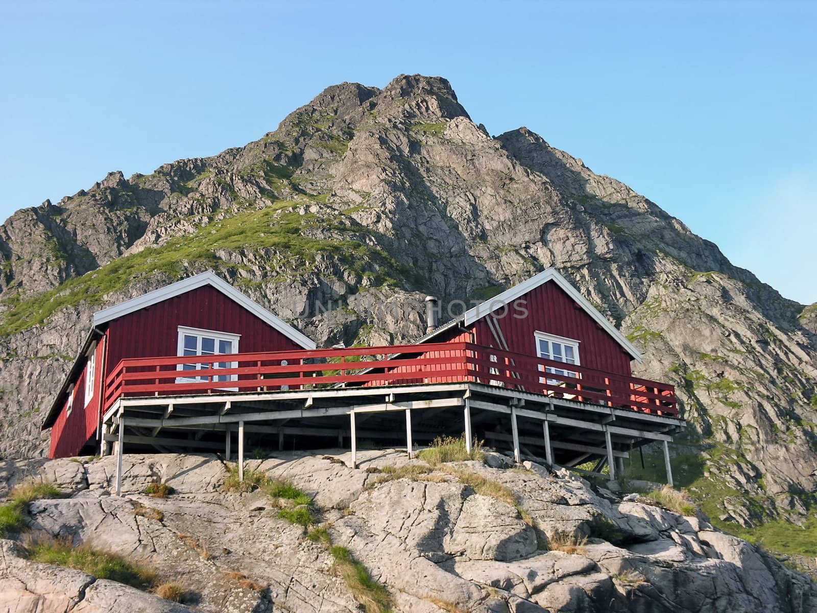 Two wooden red cottage on the mountain by rigamondis