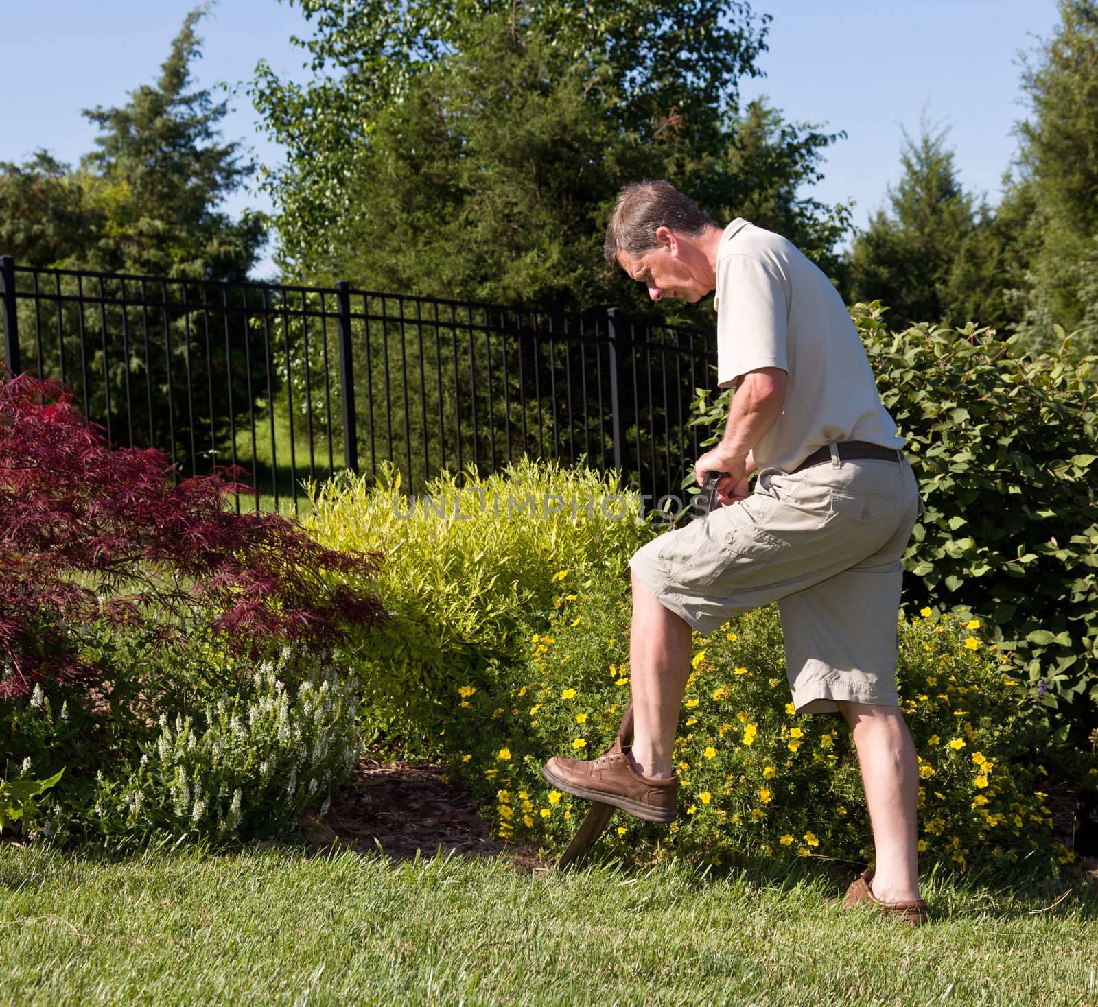 Senior man digging in garden by steheap