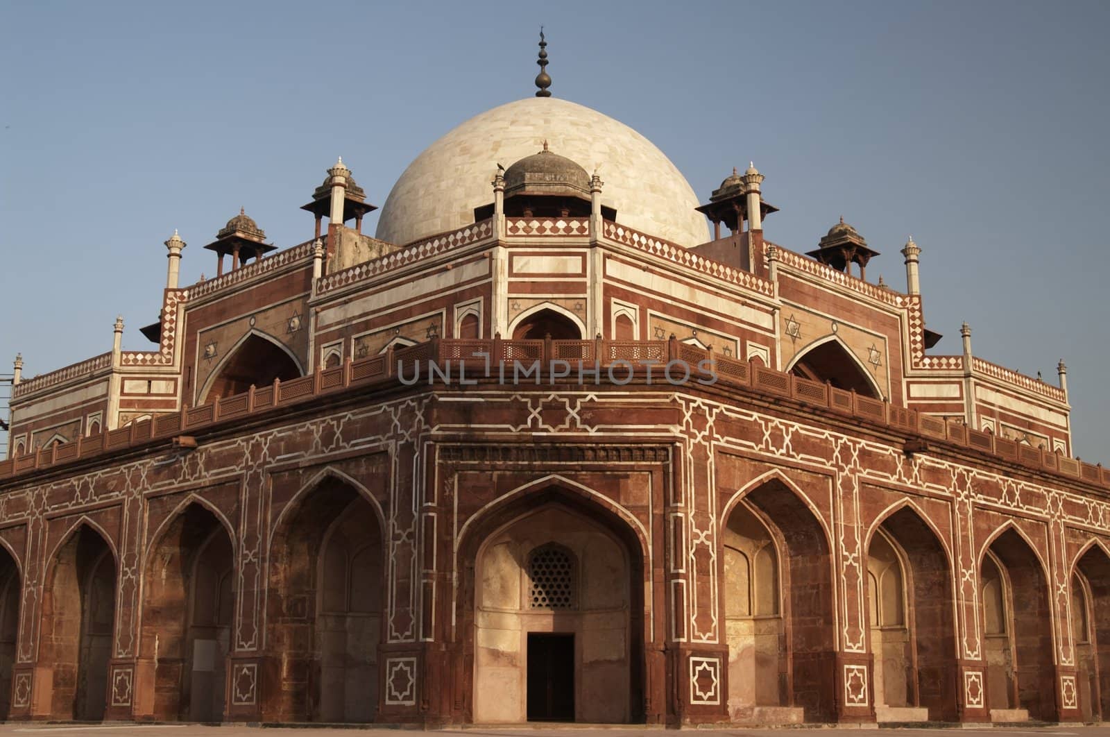 Humayun's Tomb. Islamic mausoleum. Large red sandstone building decorated with inlaid white marble and topped with white marble dome. Delhi, India