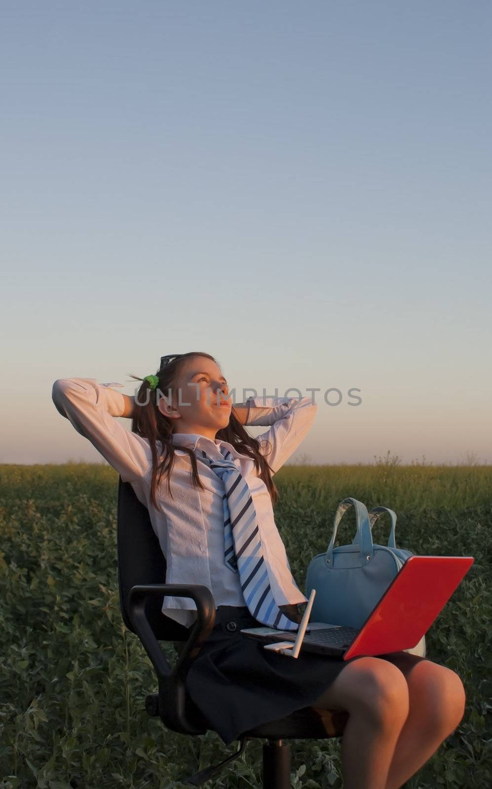 Teen girl sitting with a laptop by AndreyKr