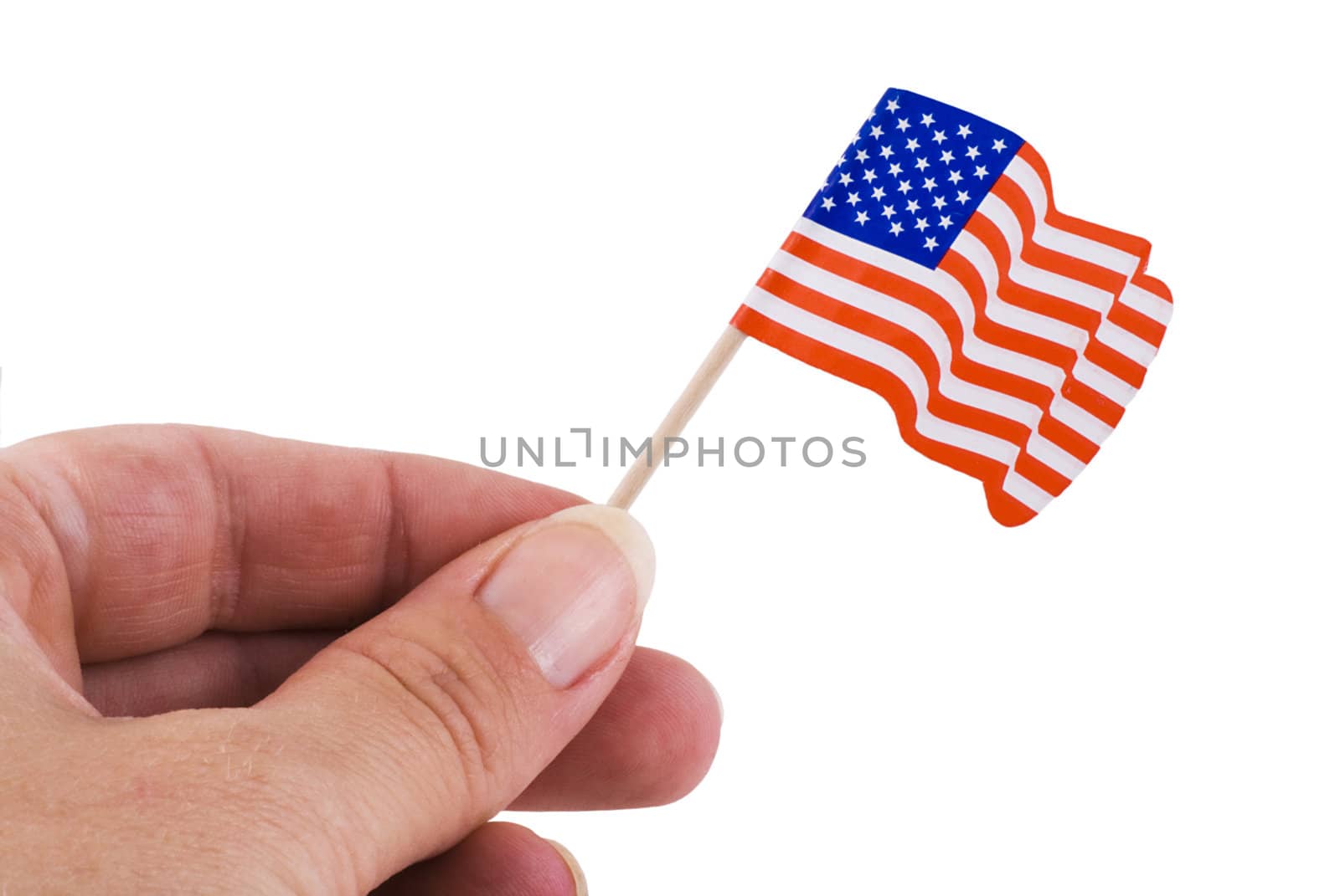 Hand holding up a little american flag, isolated on white.
