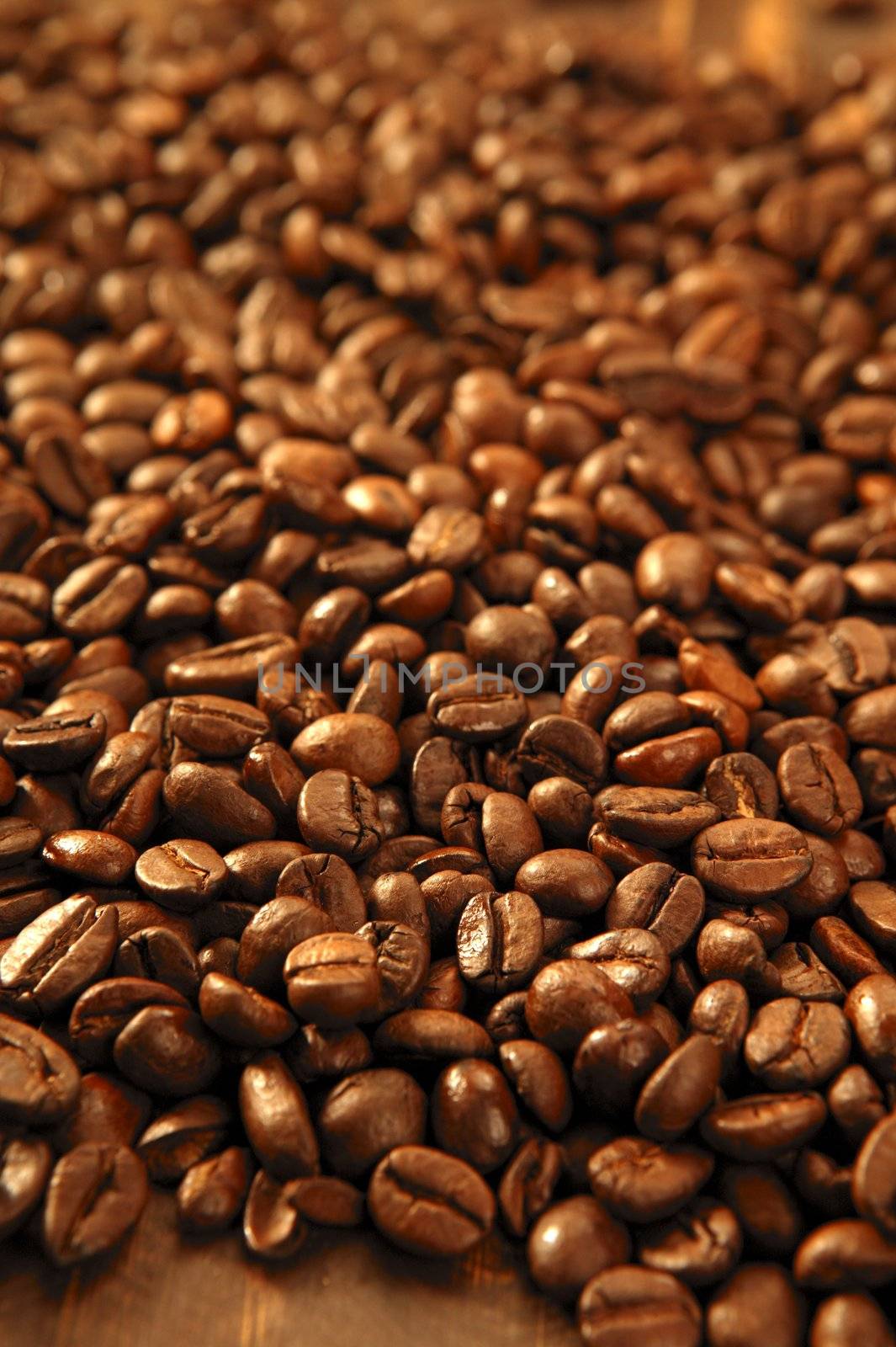 Toasted coffe beans texture under golden light