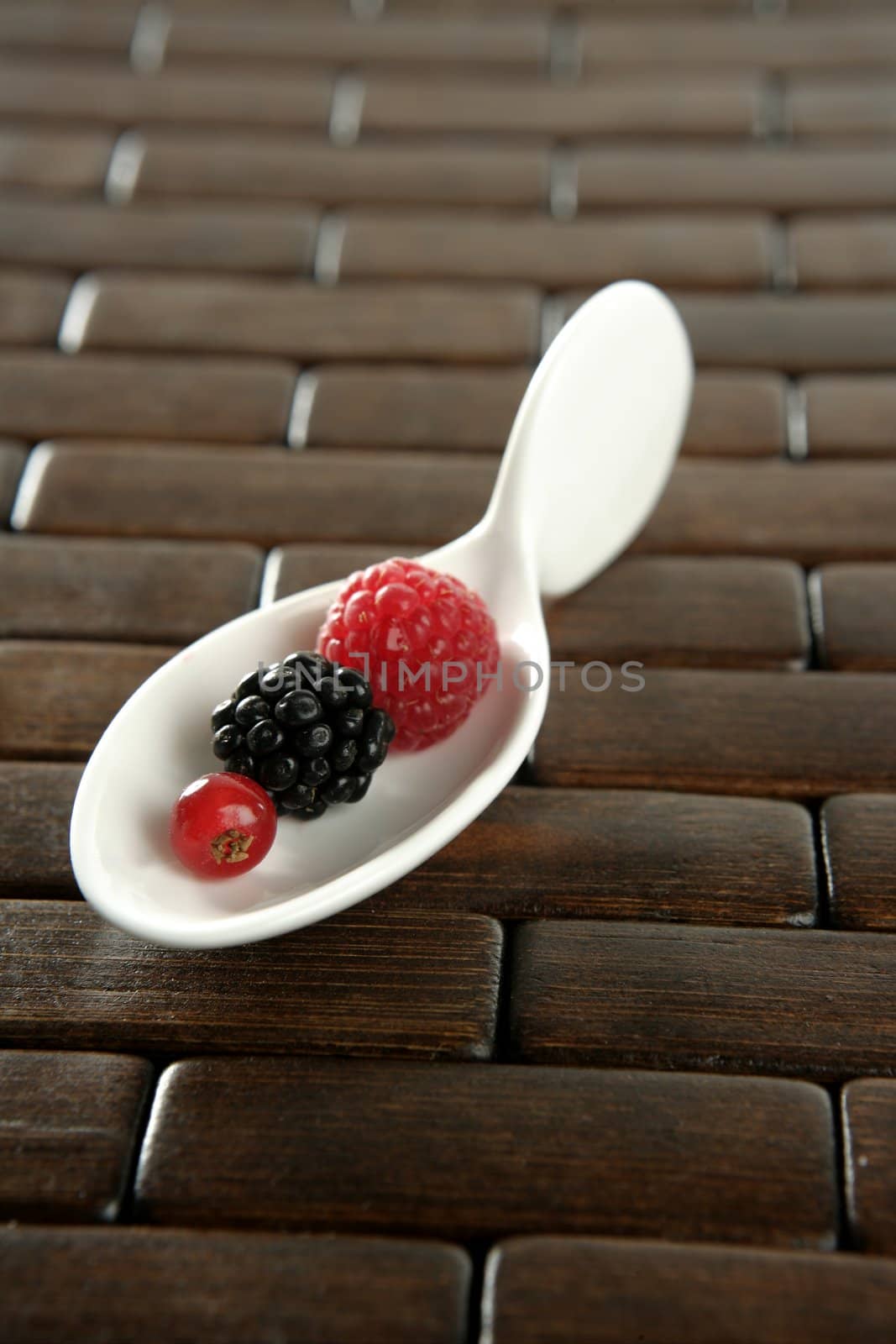 Berries in a white spoon by lunamarina