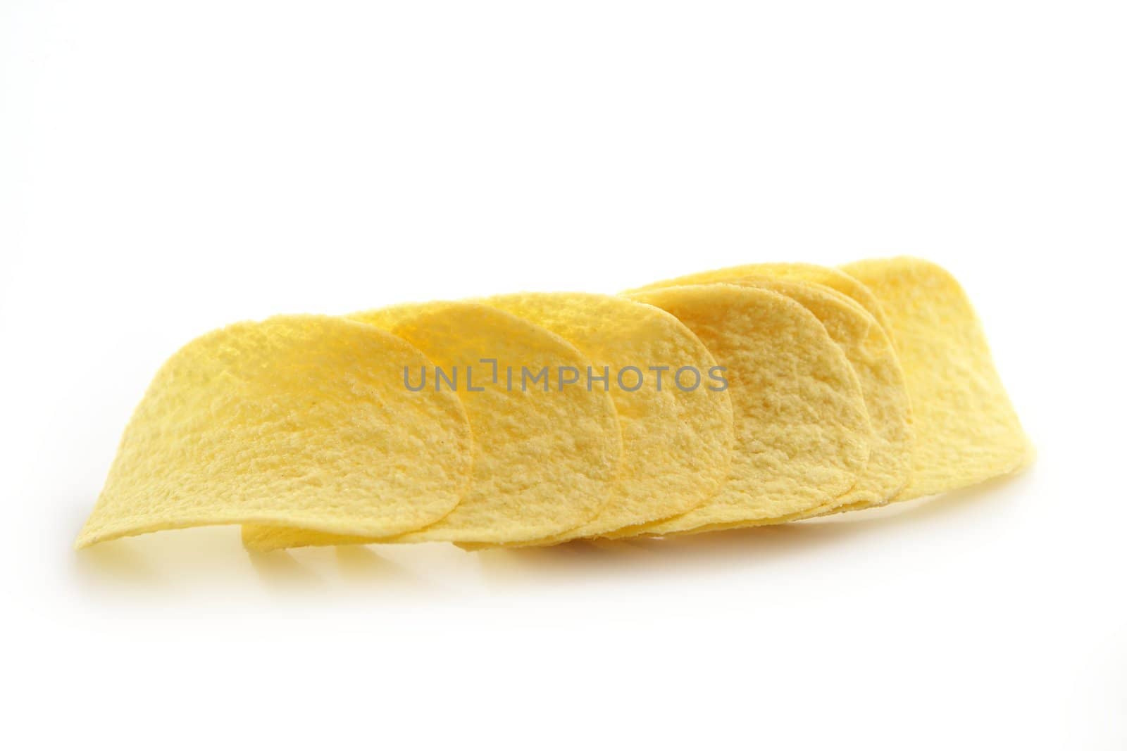 Potato salted chips slices over white background