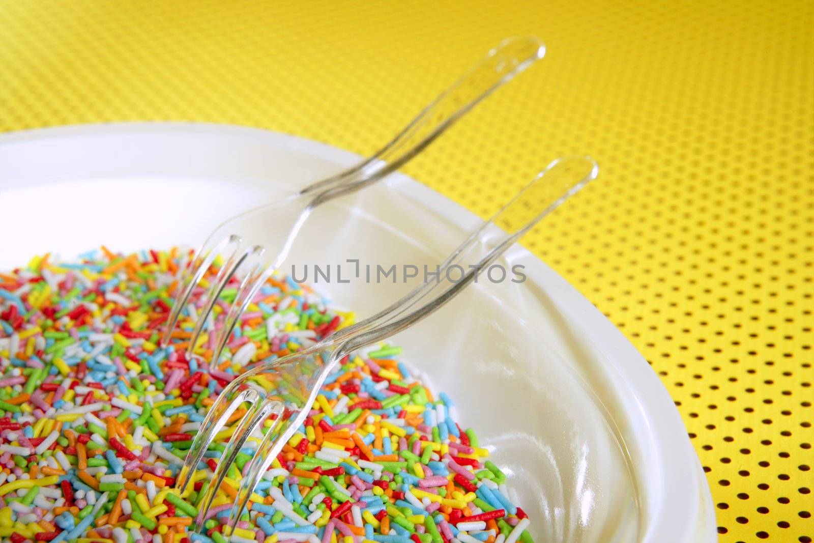 Colorful little sweet candy plate with fork, children delice