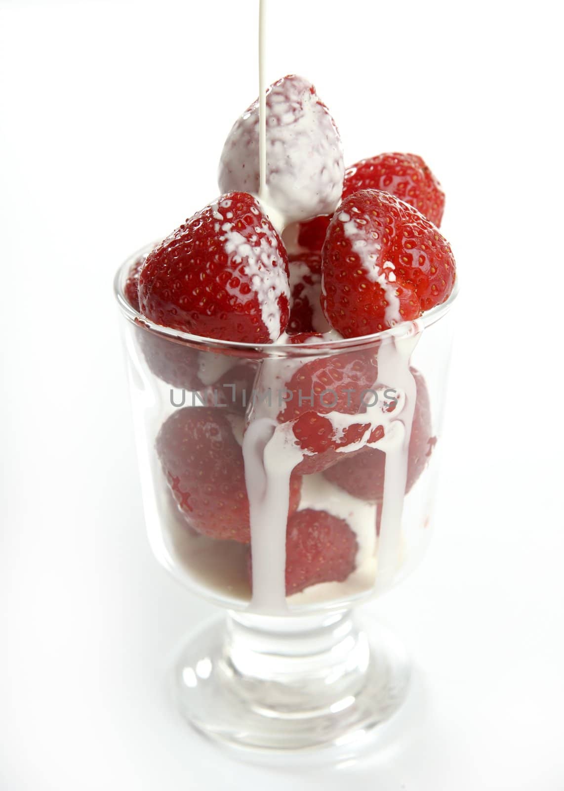 Glass full of delicious Strawberries and liquid cream