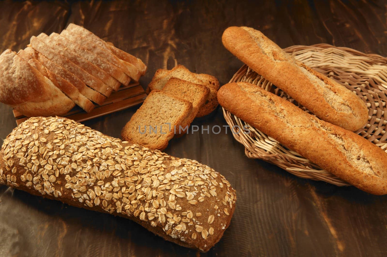 Varied bread still life over dark wood background