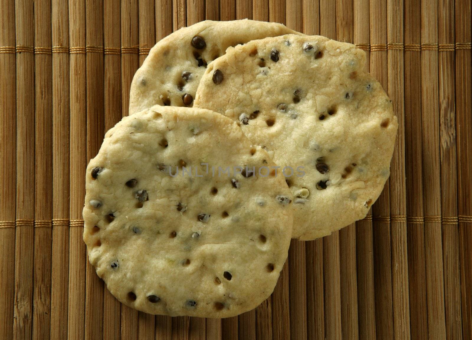 Sesame seeds biscuits over bamboo stripes