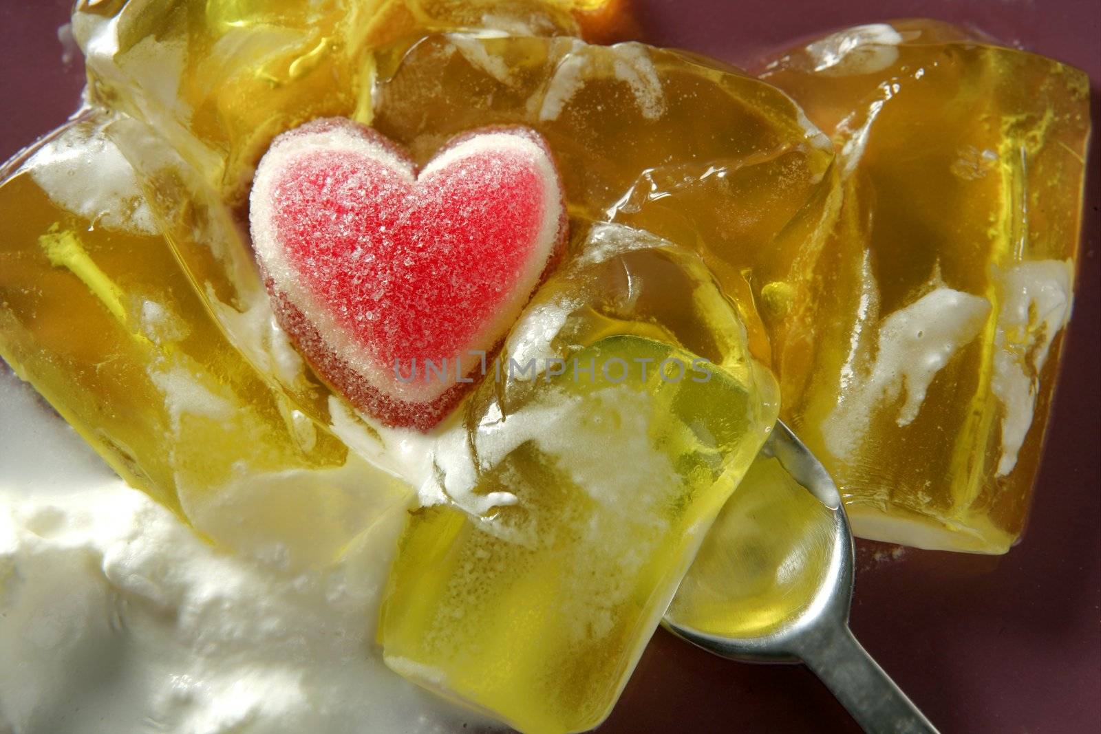 Spoon eating a Valentines hearth with lemon jelly and cream