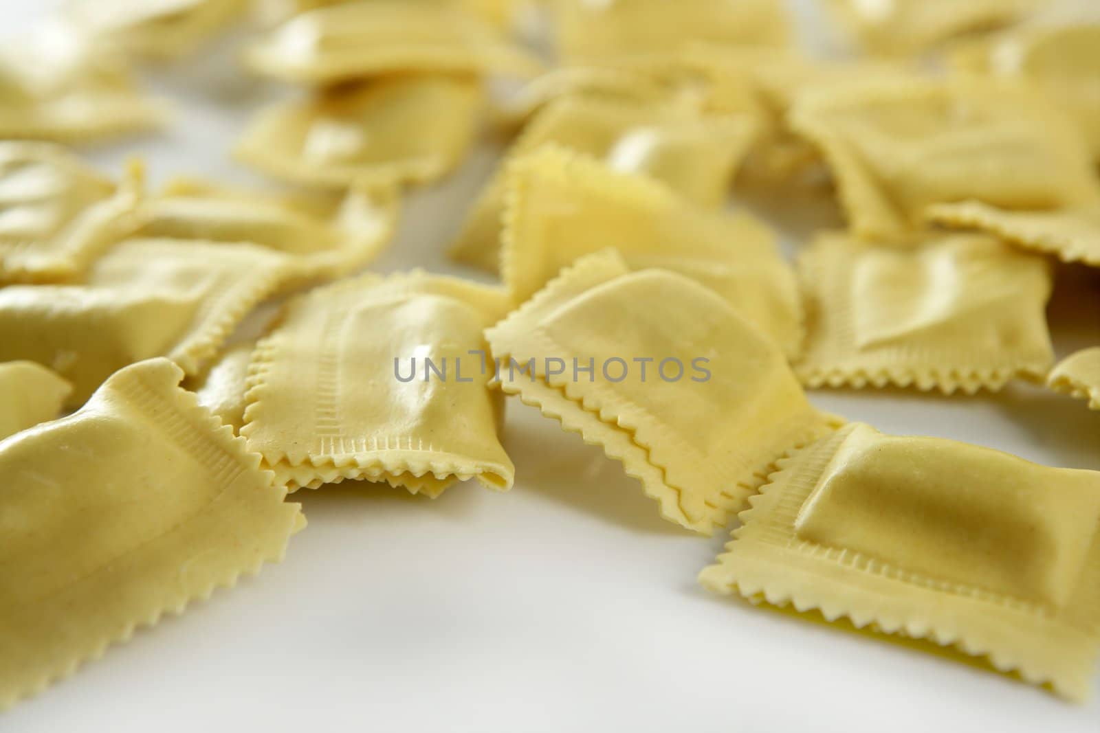 Cheese filled Italian yellow pasta texture, white background