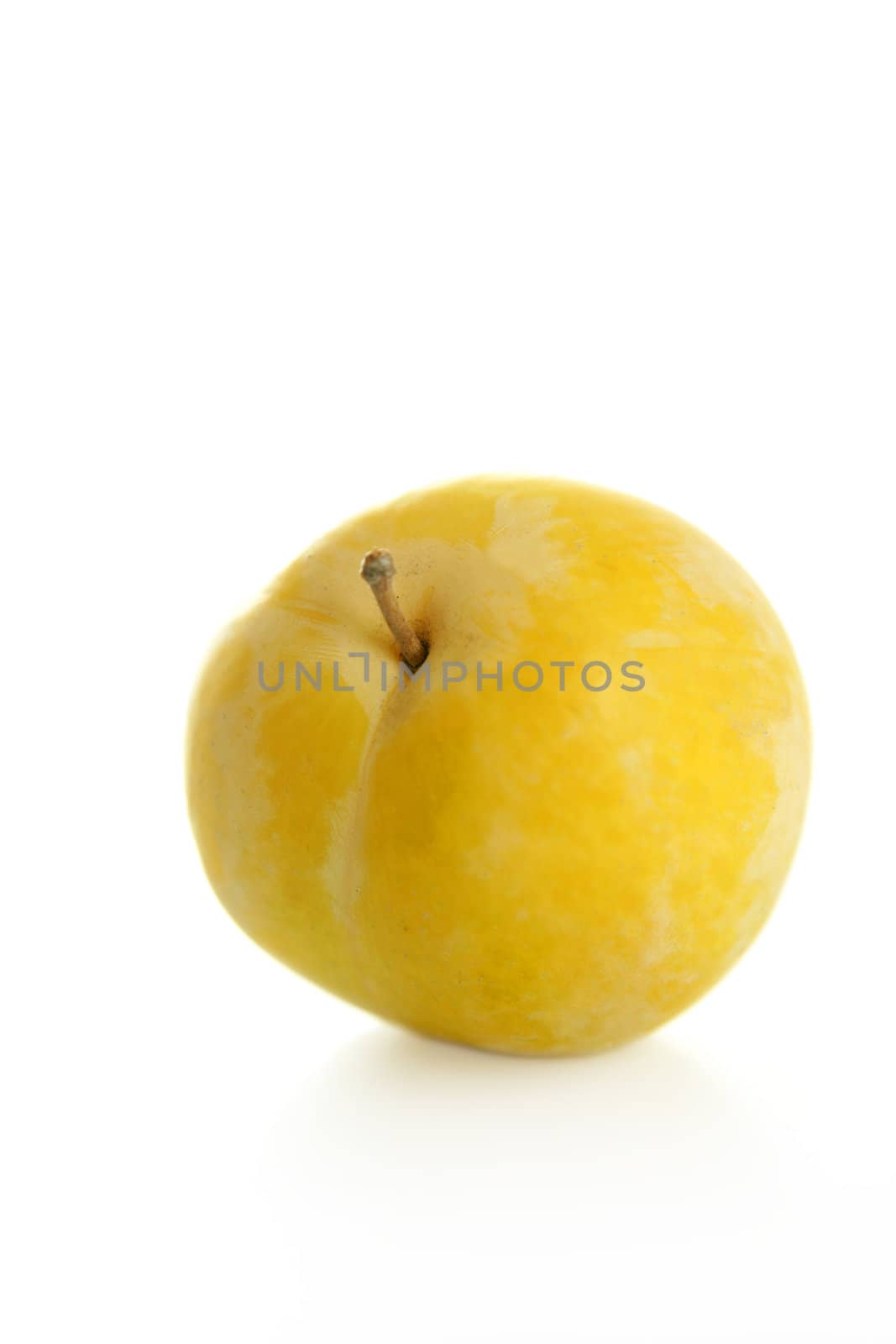 Close up of yellow Mirabelles on white studio background