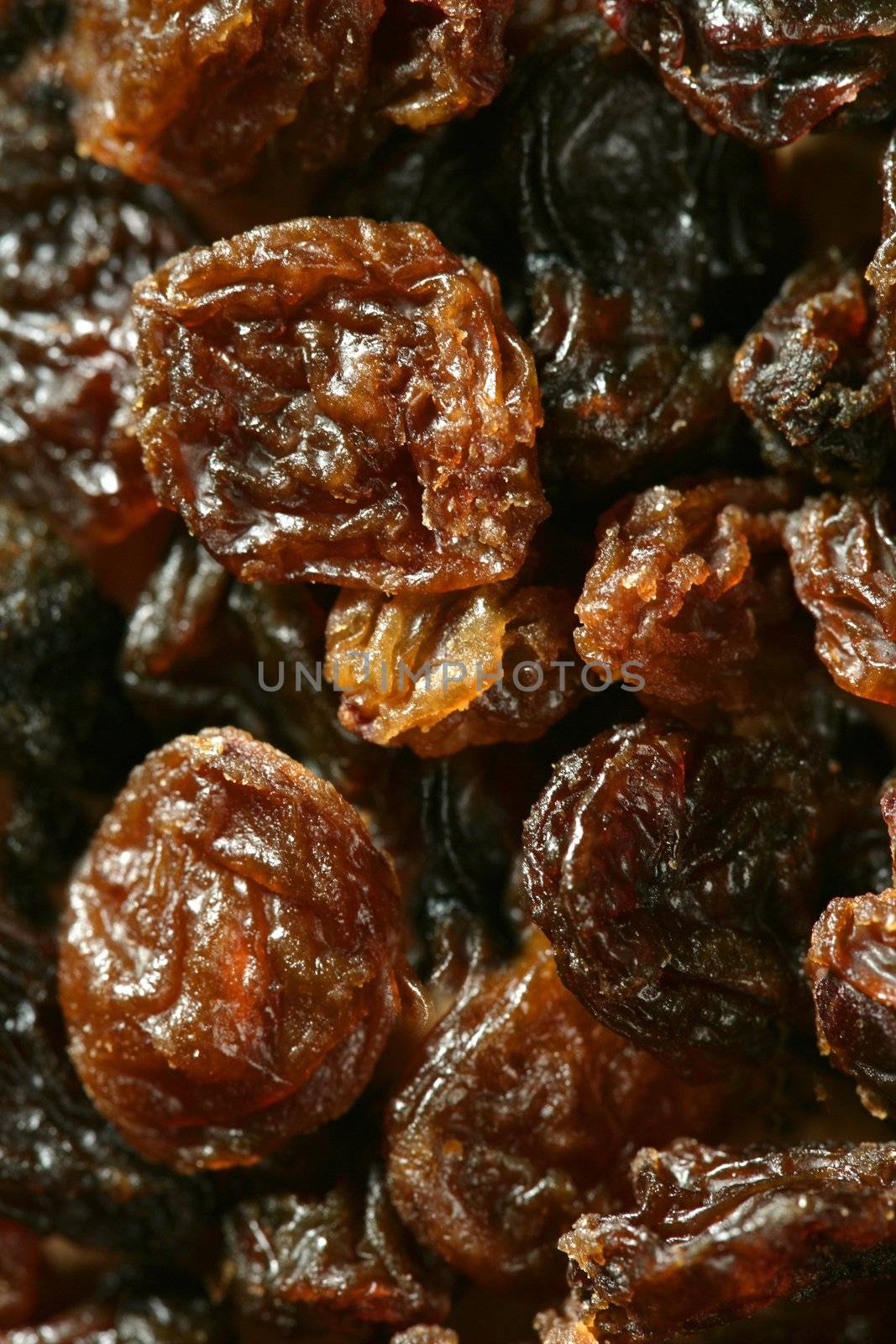 dried raisin macro texture in a close up crop. atural fruits brown background