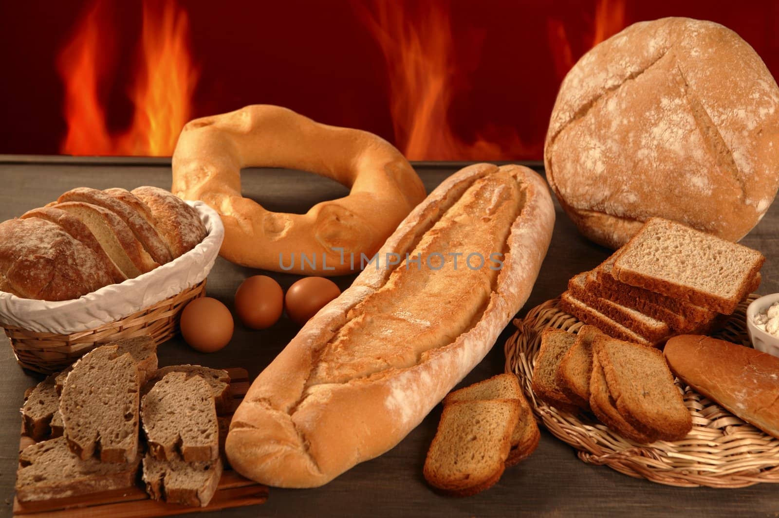 Bread still life with varied shapes and bakery fire in background