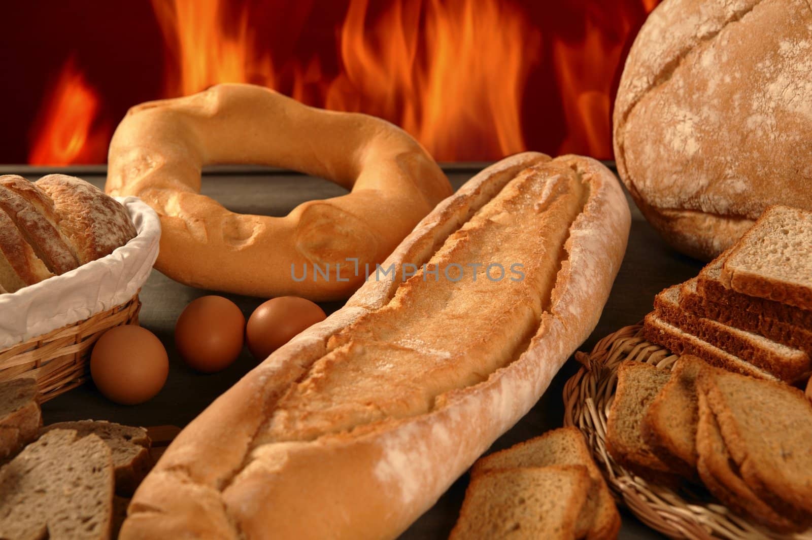 Bread still life with varied shapes and bakery fire in background