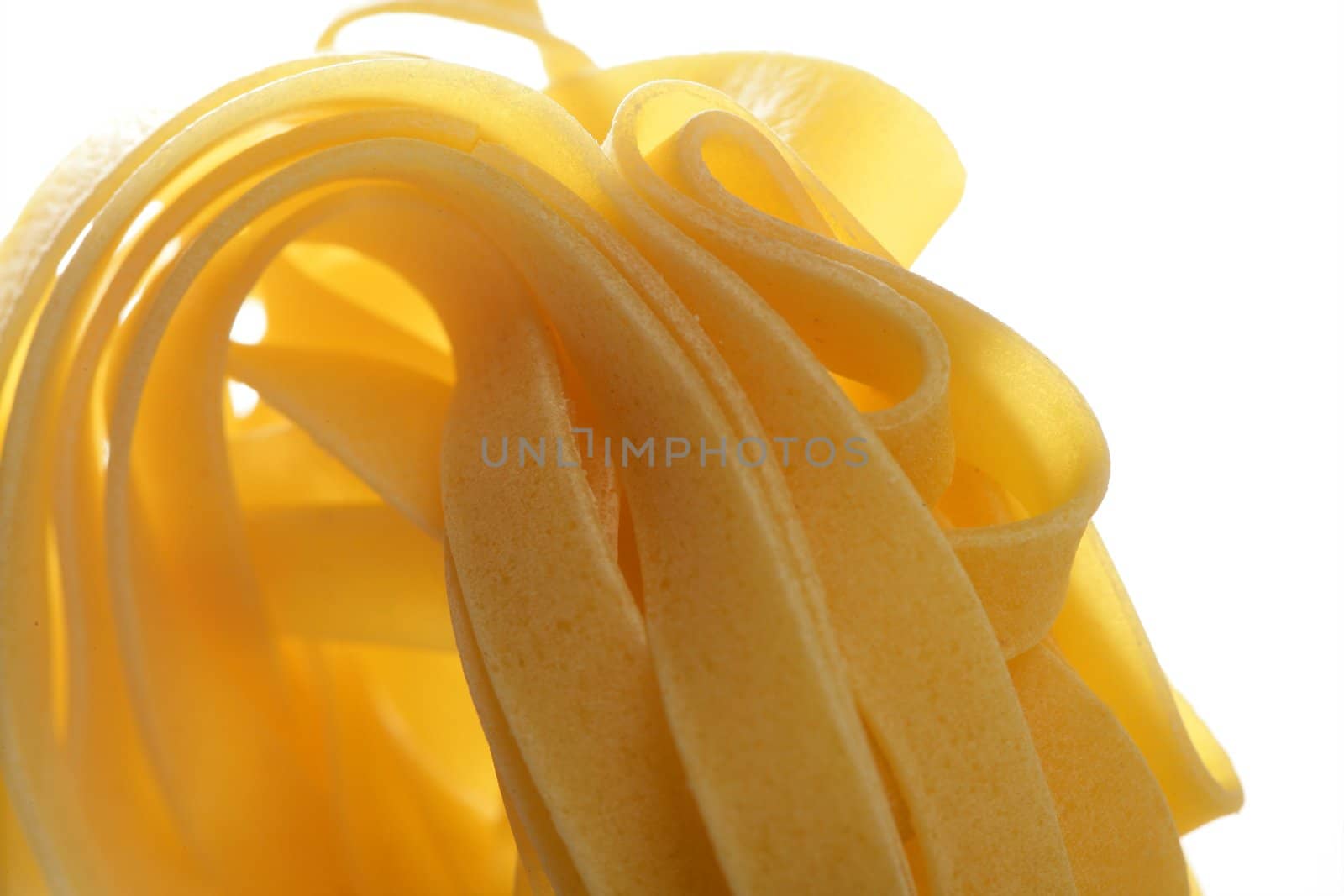 Dried macro noodles yellow pasta, studio shot by lunamarina