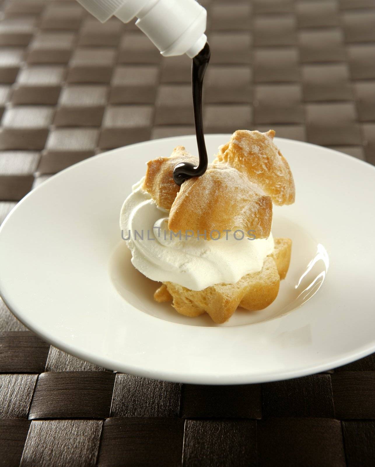 Delicious cream puff cake with chocolate syrup by lunamarina