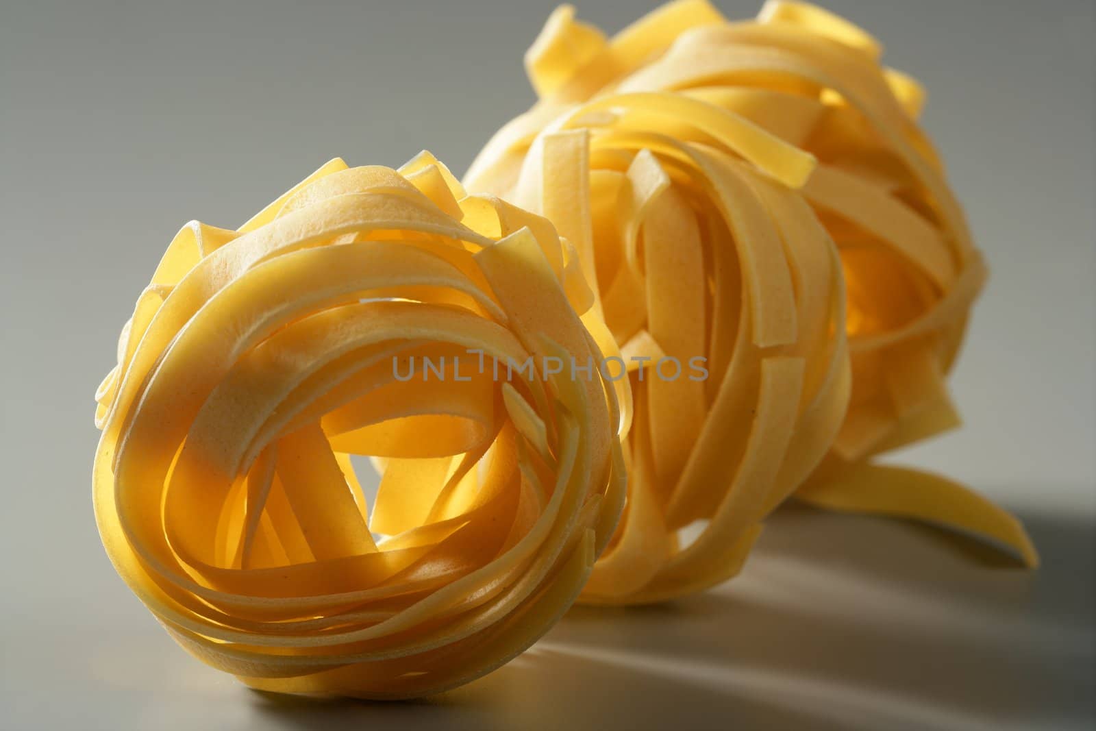 Dried macro noodles yellow pasta, studio shot texture