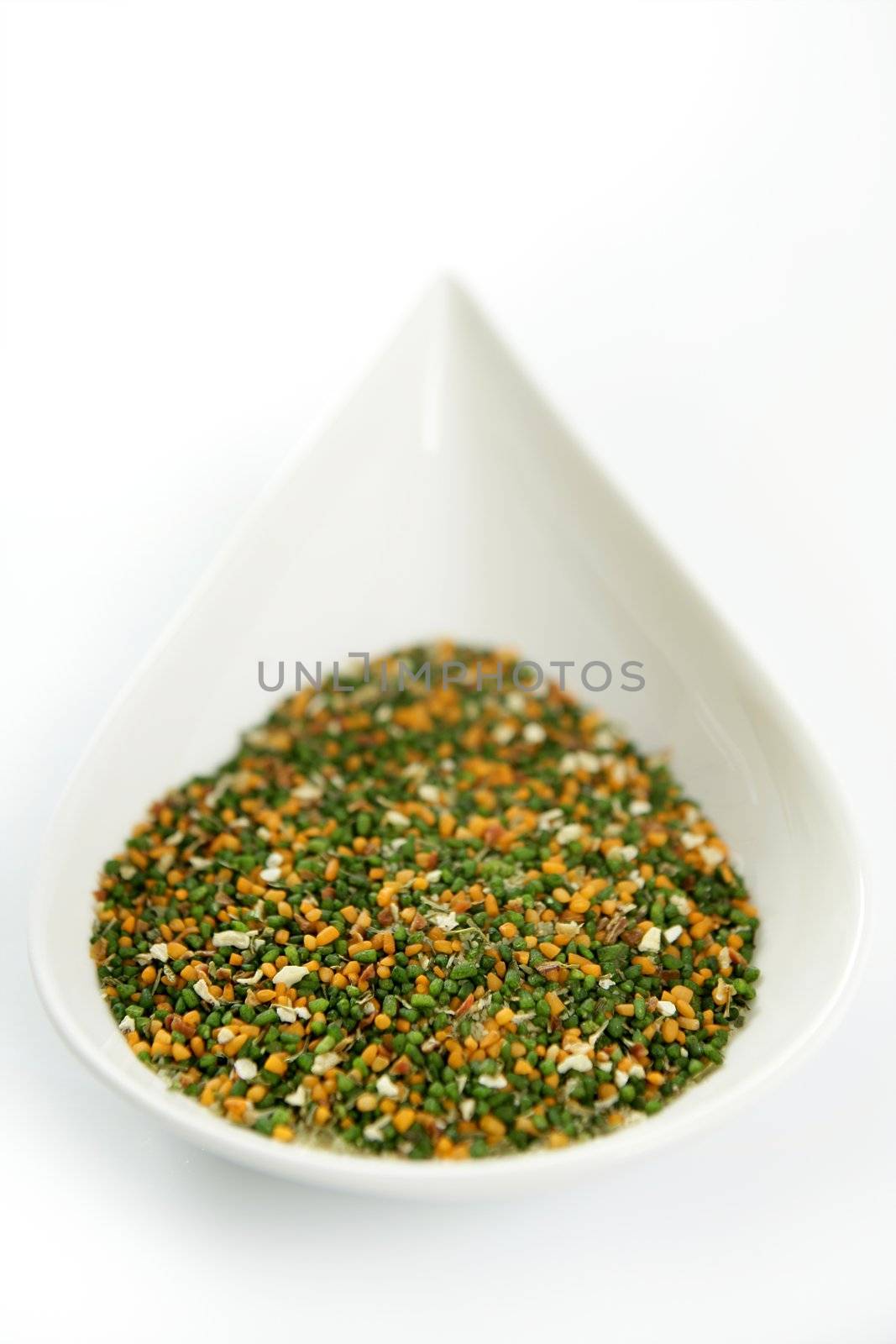 Multicolor vegetables semolina textures in white dish, white background