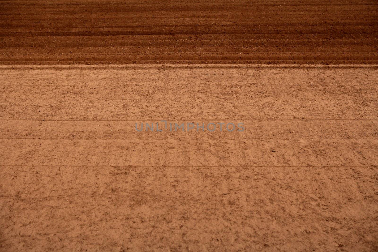 Ploughed red clay soil agriculture fields by lunamarina