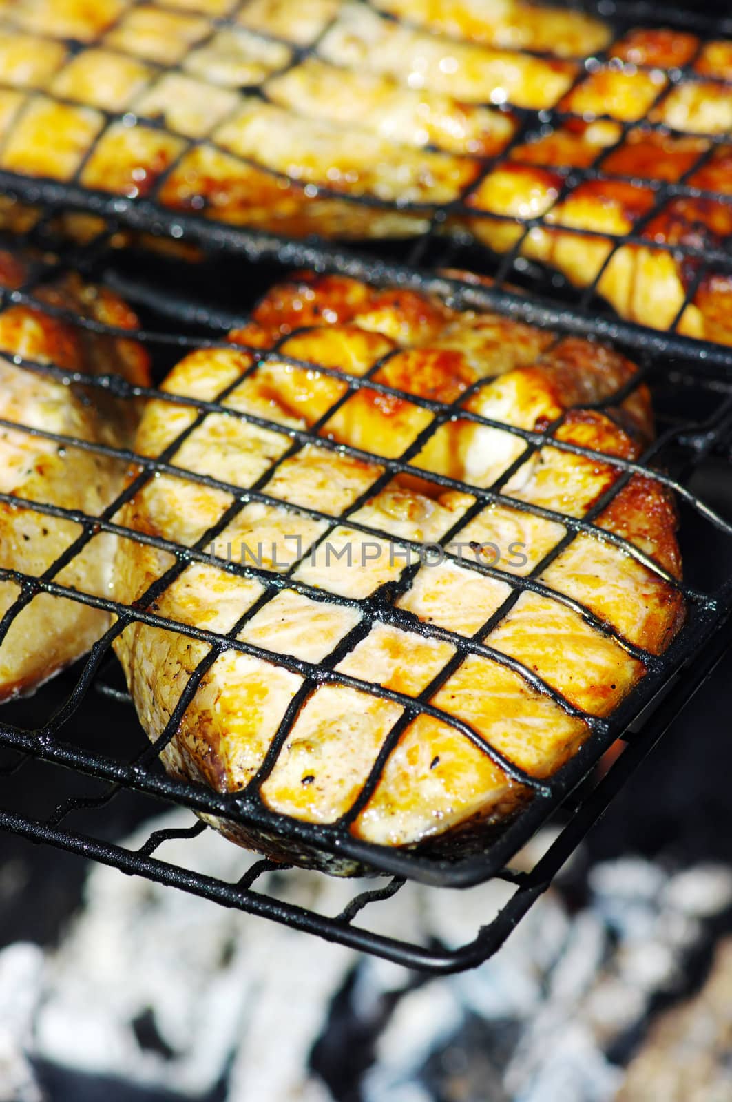 fresh salmon fillet cooking on barbecue.