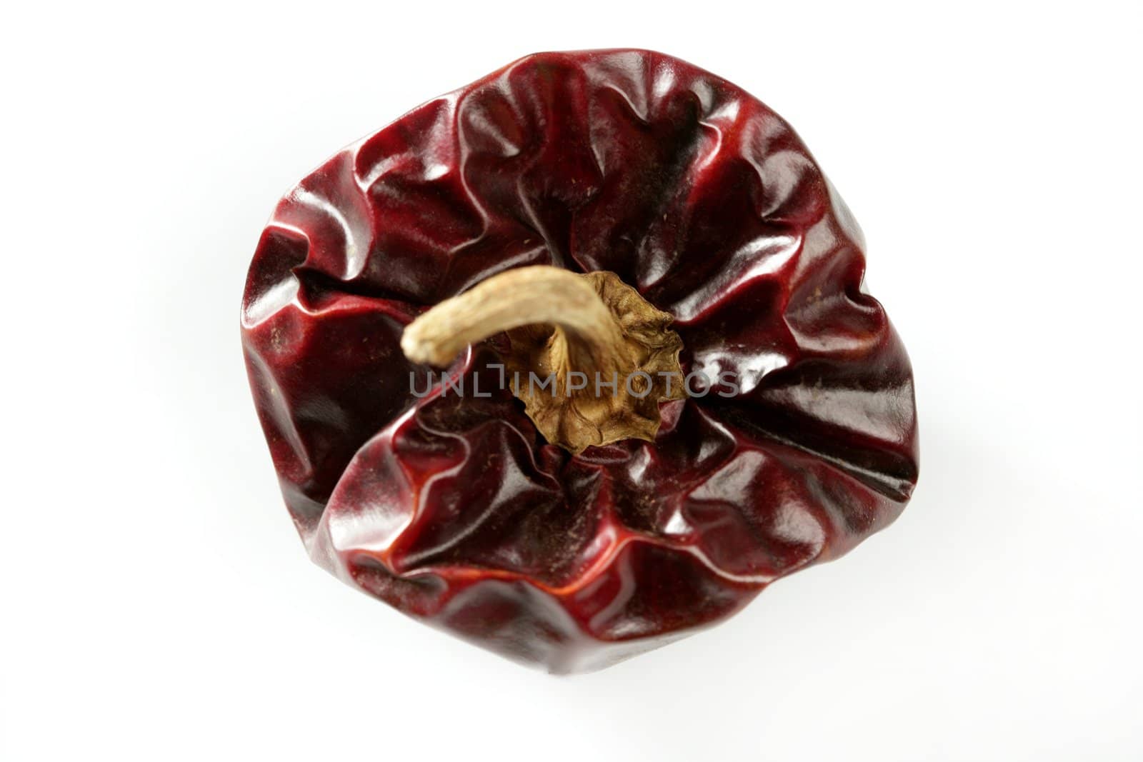 One round Mediterranean dried dark red peppers by lunamarina