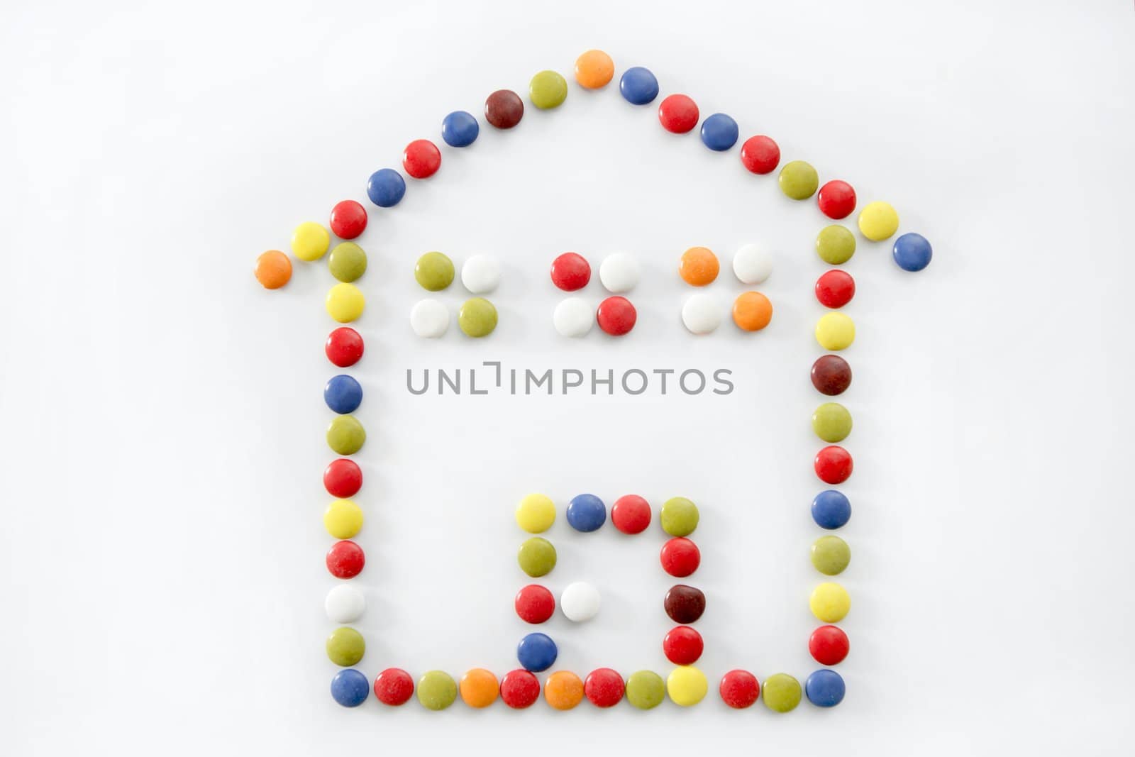 chocolate little candy sweets, house shape, isolated over white