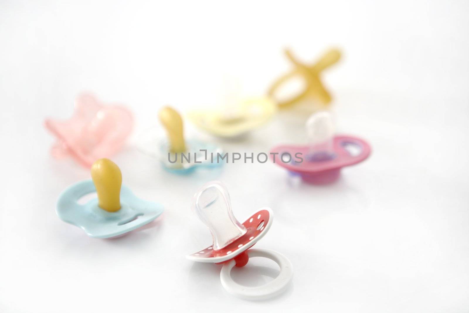 baby pacifier set over white background by lunamarina