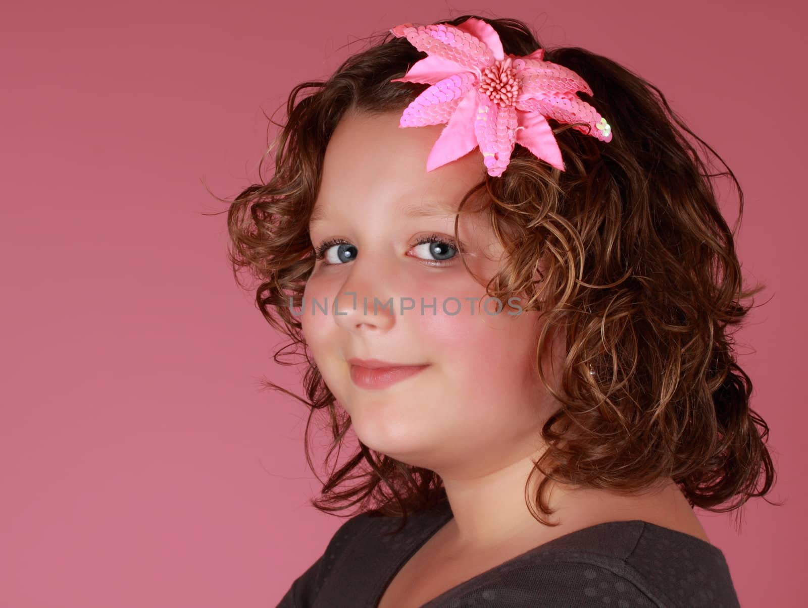 portrait of a preteen girl, pink background