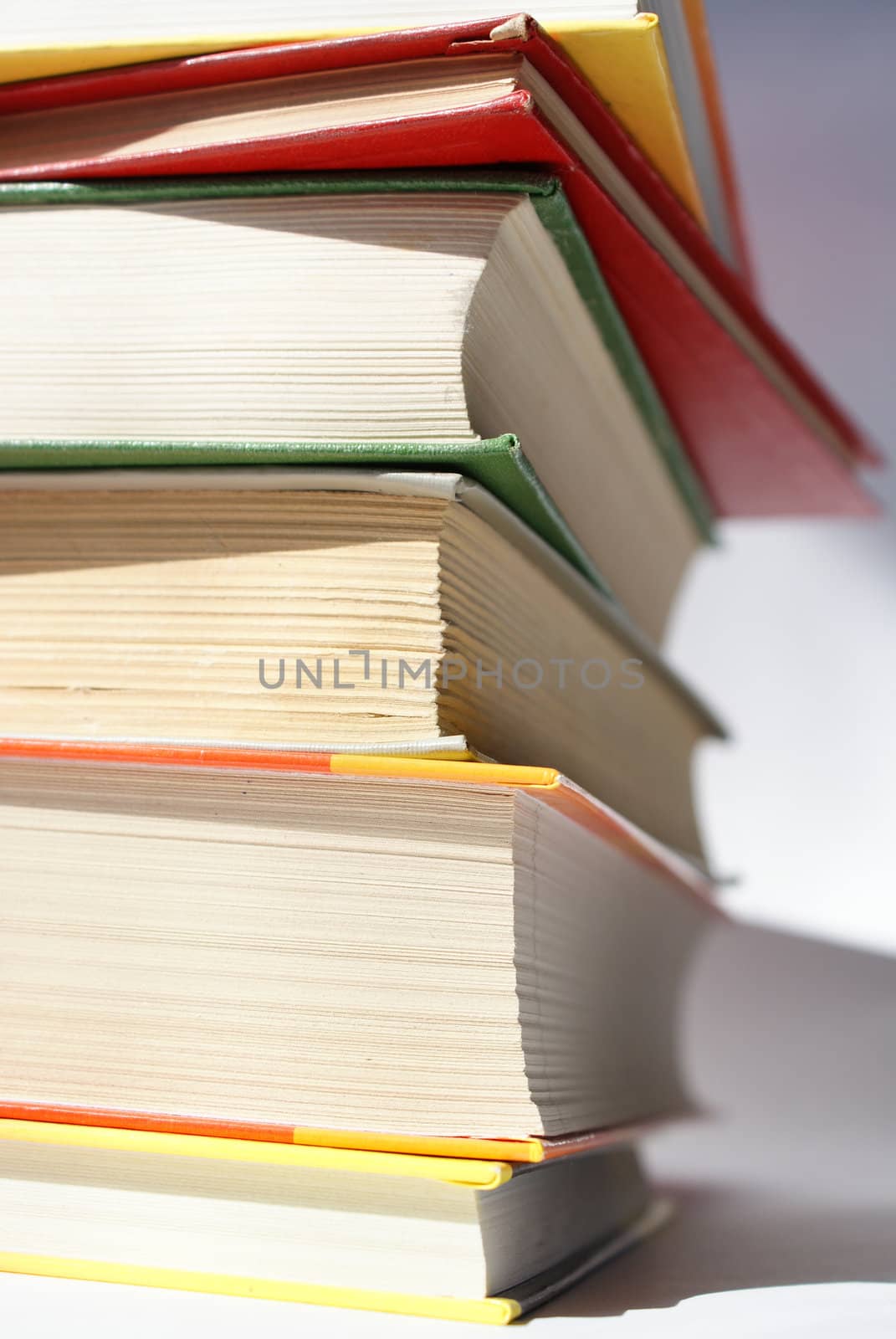 books of different colors stacked and shot in a closeup