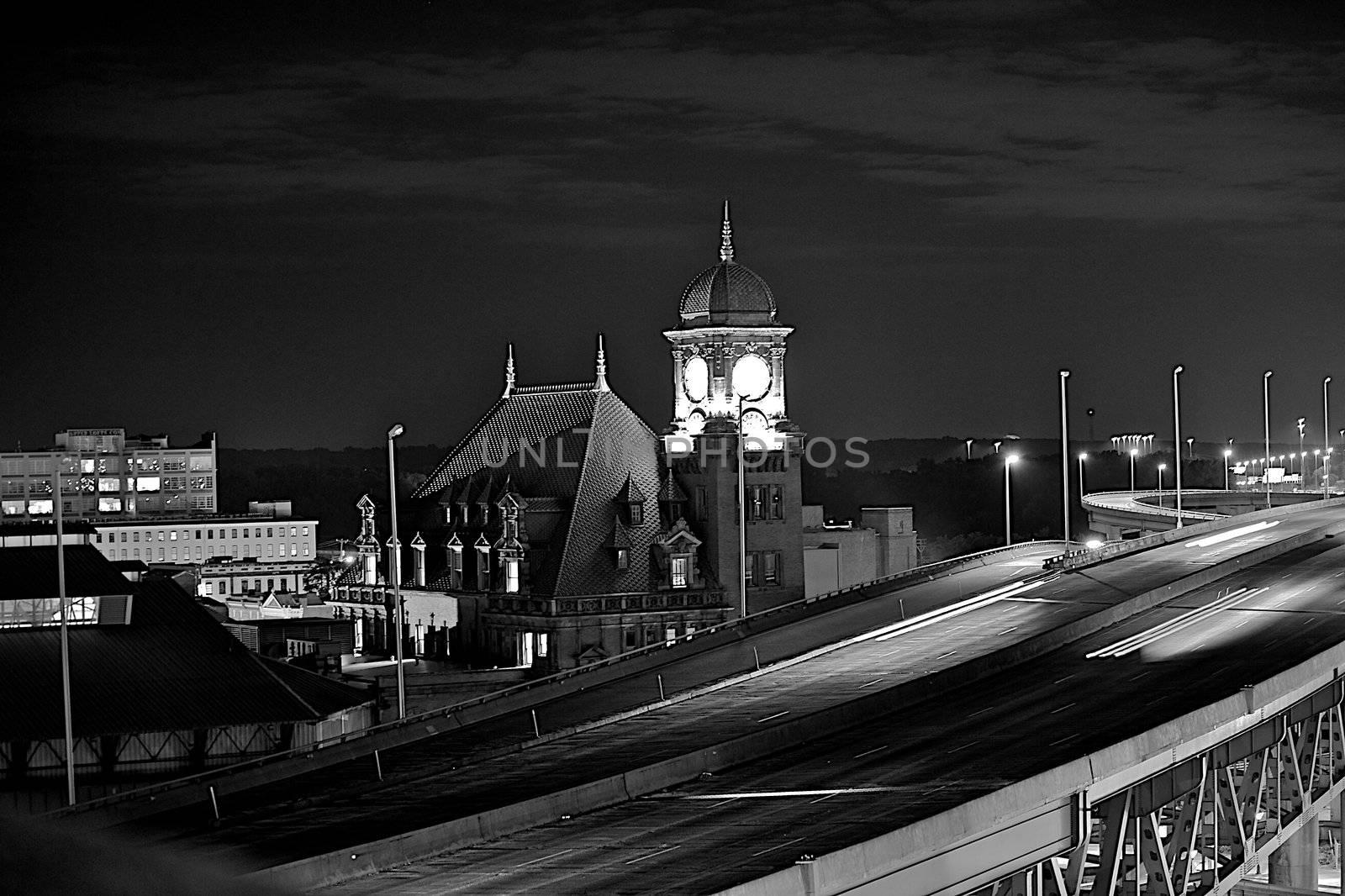 Traffic on Interstate 95 in Richmond, Virginia.   Clock tower and city in the background.  Black and White.
