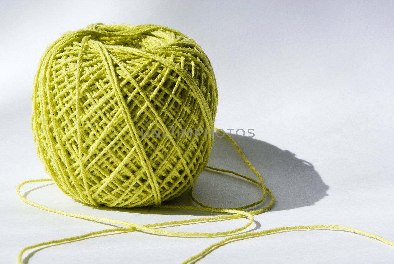 knot of green yarn against light background
