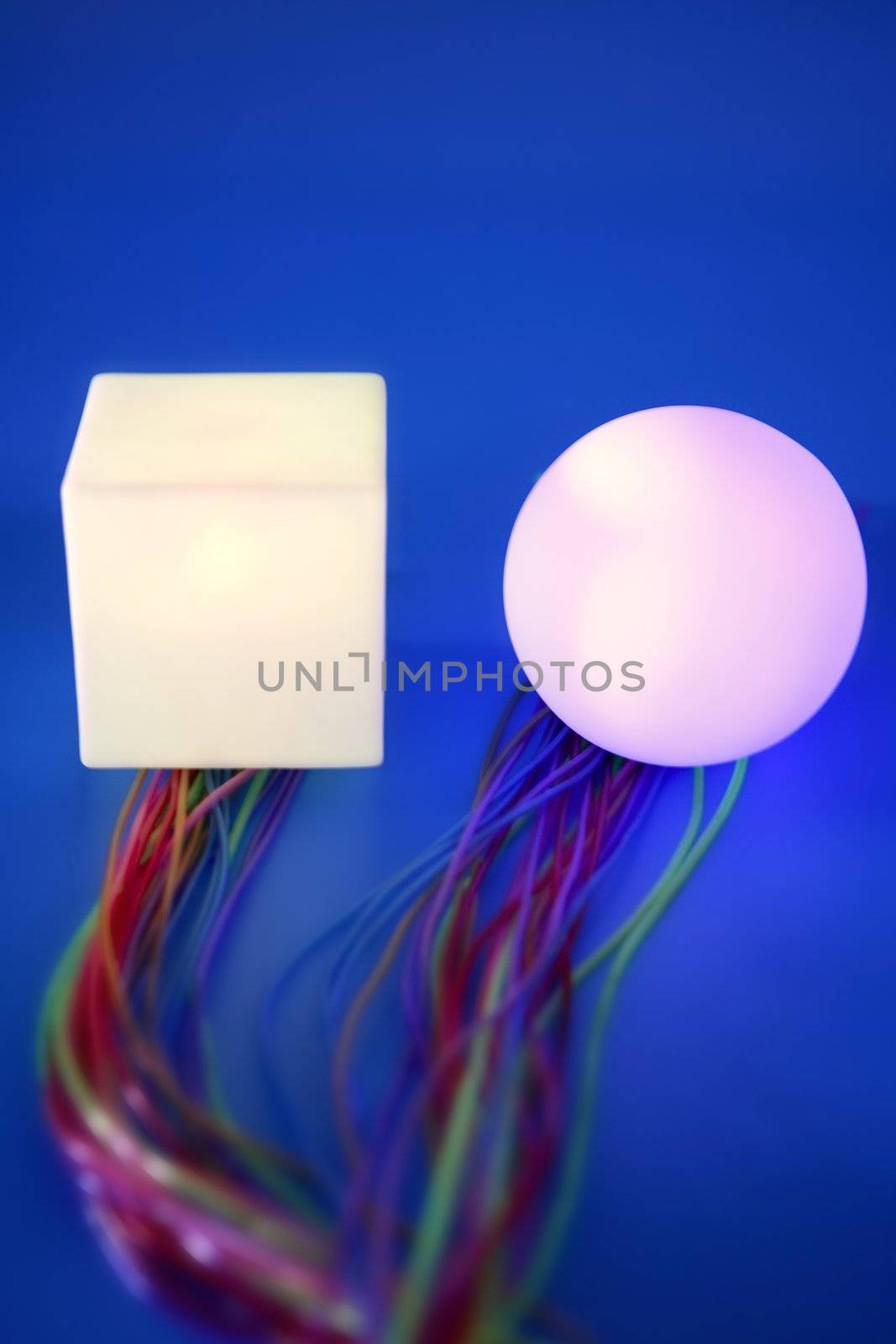 Glowing sphere and square with colorful wires, wired communication metaphor