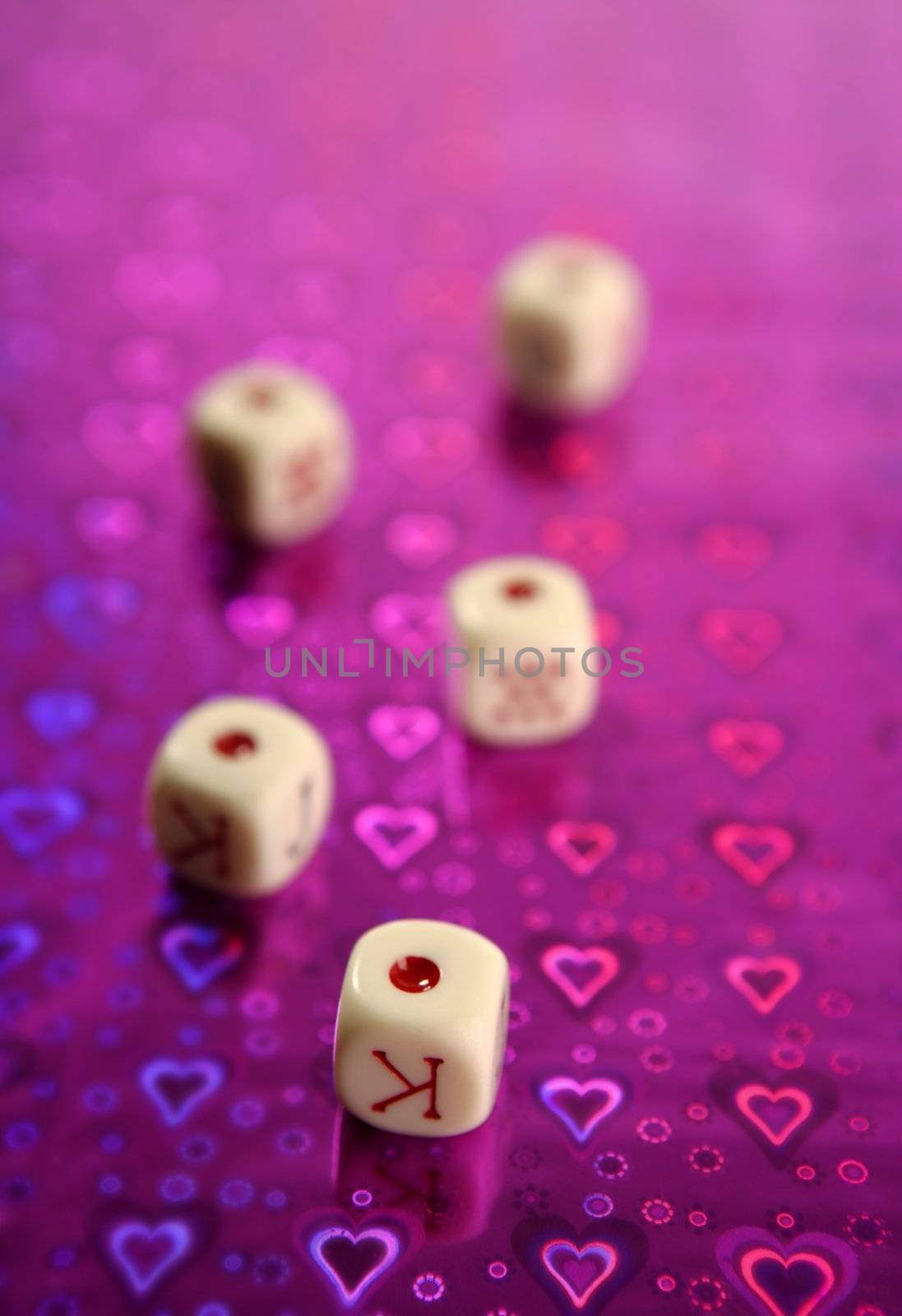 Poker dices over colored background, selective focus