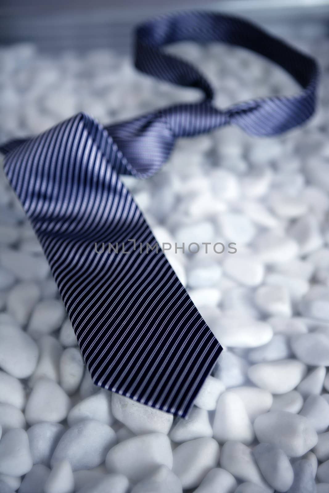 left his tie on a modern white stones table by lunamarina